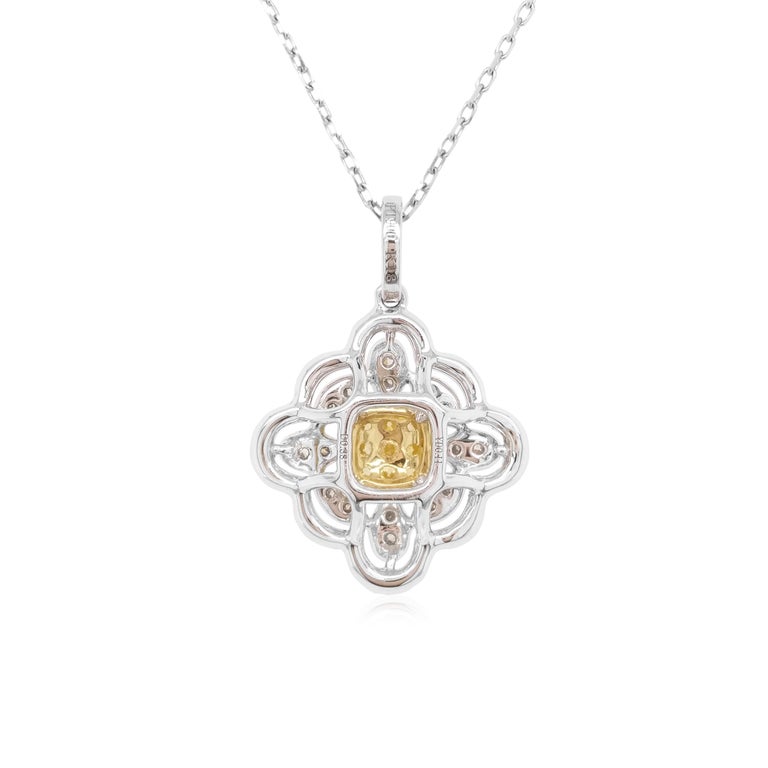 This exclusive pendant features luscious natural Yellow diamonds at the heart of the design, by framing an ornate arrangement of delicate white diamonds set in platinum. Bold and striking, this unique pendant is the perfect statement piece -