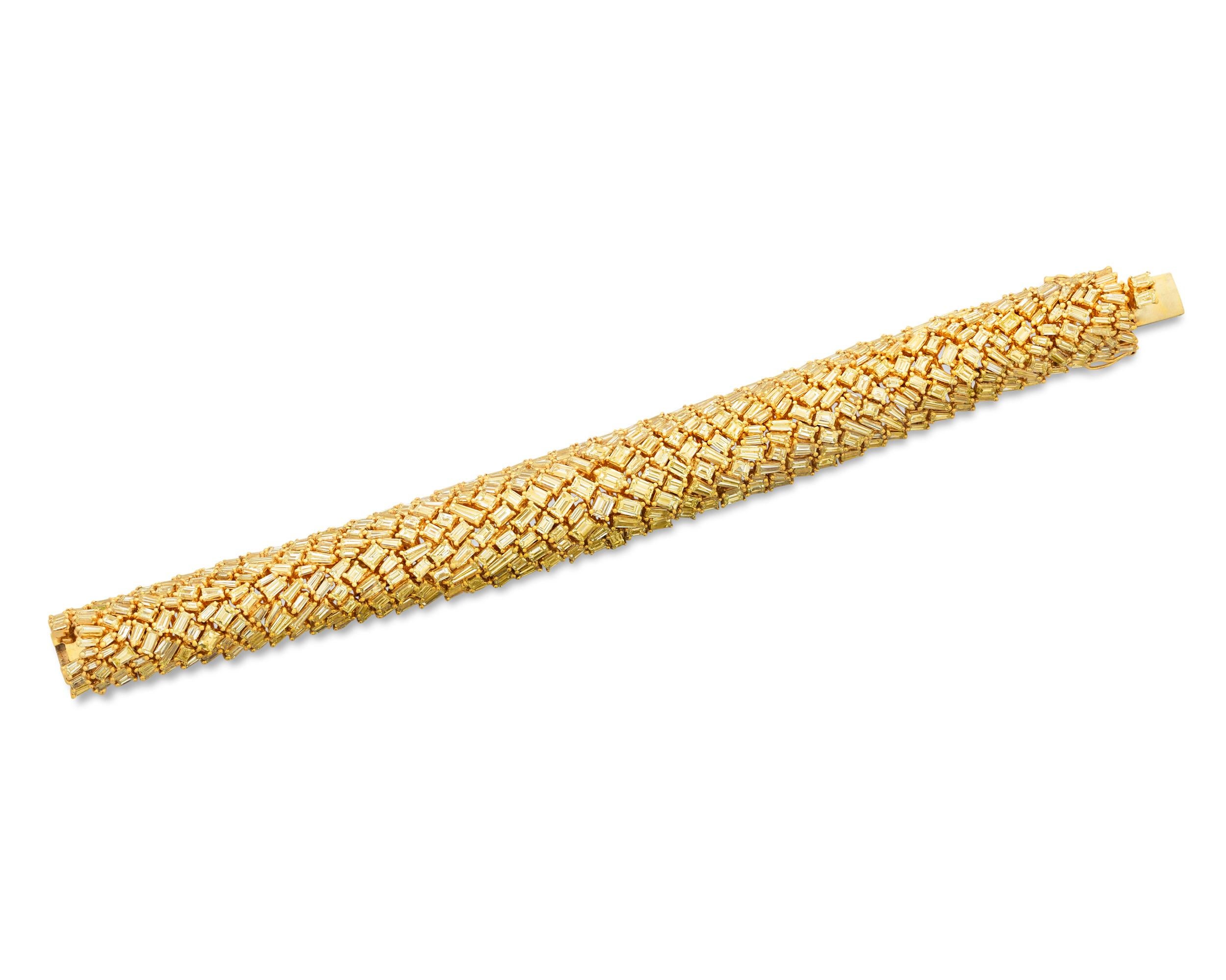 An array of beautifully matched yellow diamonds totaling 31.47 carats comprise this stunning bracelet. Set in 18K yellow gold, these vibrant, baguette-cut diamonds are meticulously fit together in a breathtaking diamond mosaic and sparkle with