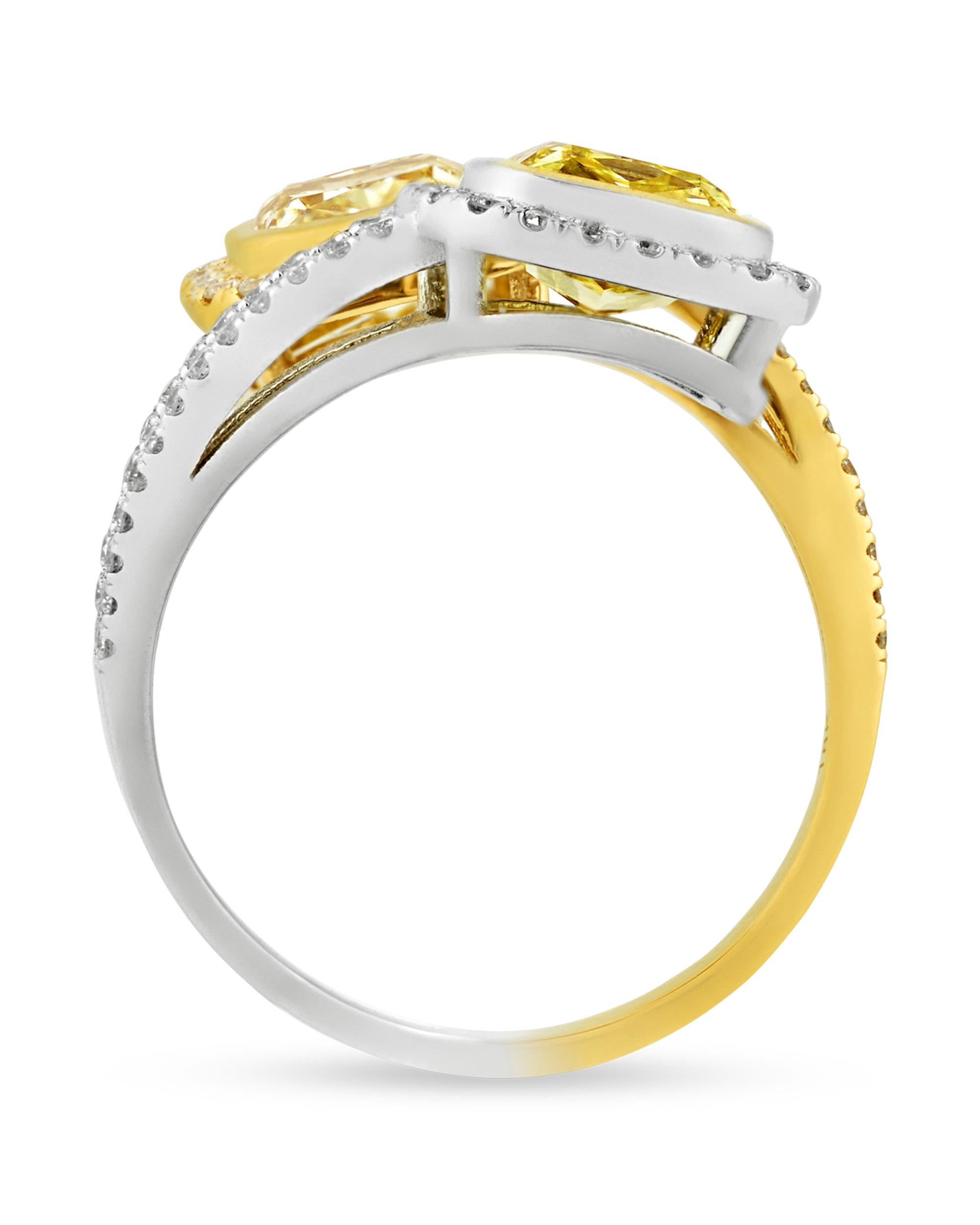 Distinguished for its elegant craftsmanship and exquisite gems, this stunning bypass ring features two striking yellow diamonds totaling 2.40 carats. The sunny diamonds are accented by halos of white diamonds totaling 0.54 carat. The artful bypass