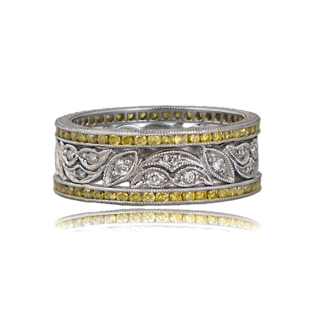 Indulge in the allure of this estate-style diamond wedding band. The center row boasts a captivating leaf motif filigree adorned with diamonds, while the outer rows feature channel-set yellow diamonds. Adding to its charm, beautiful engravings grace