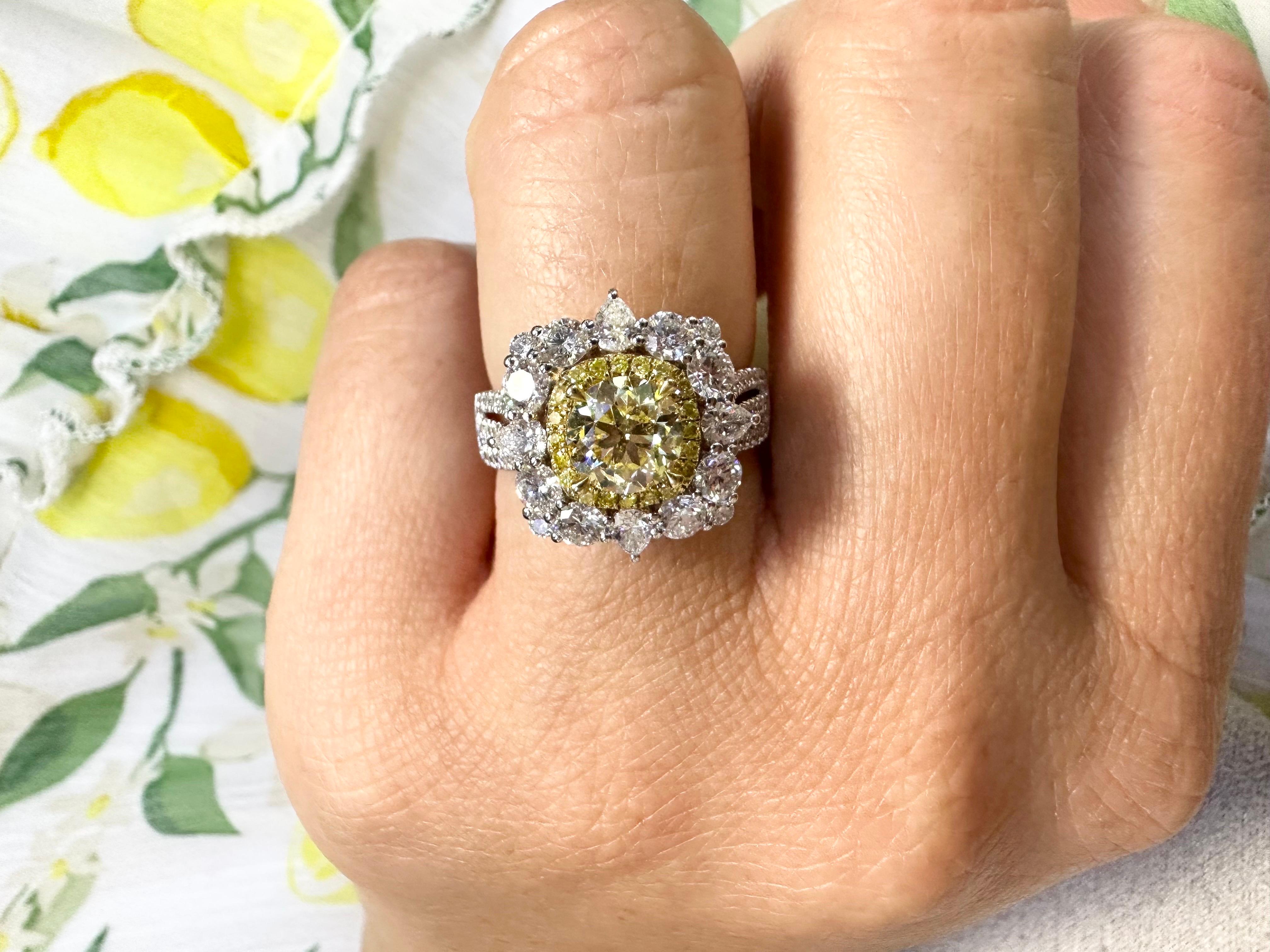 Yellow diamond engagement or cocktail ring made in 18KT white gold with excellent craftsmanship! Stunning halo with fancy yellow diamonds around center makes this ring a vivid designer ring!

Metal Type: 18KT
Gram Weight:6.37 grams 

Natural Yellow