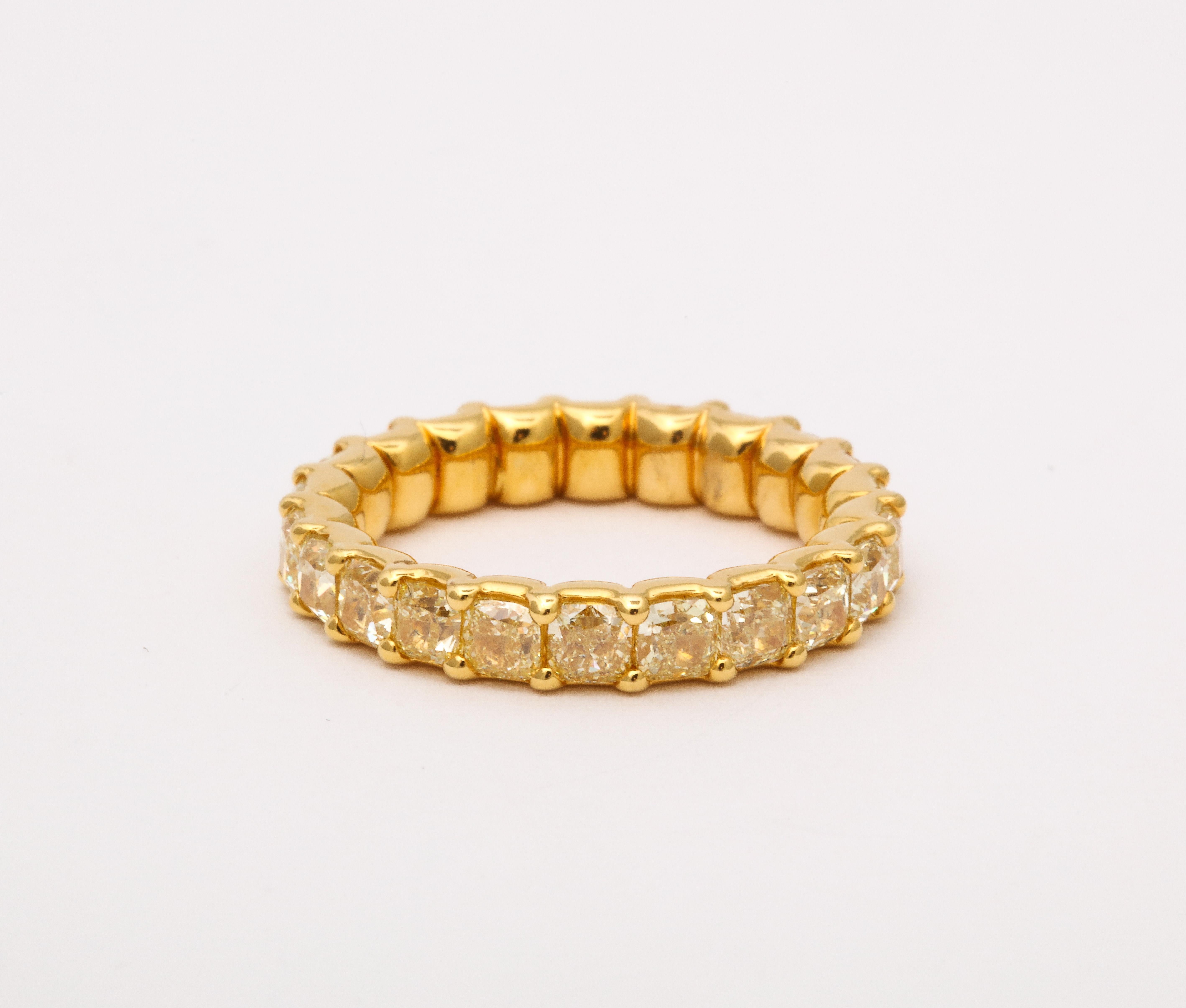
4.18 carats of Fancy Yellow Radiant cut Yellow diamonds sent in 18k yellow gold. 

Currently a size 6.75. There is a bar for sizing - this ring can easily be sized. 

Fabulous worn alone or stacked with other bands. 

3.7 mm wide. 