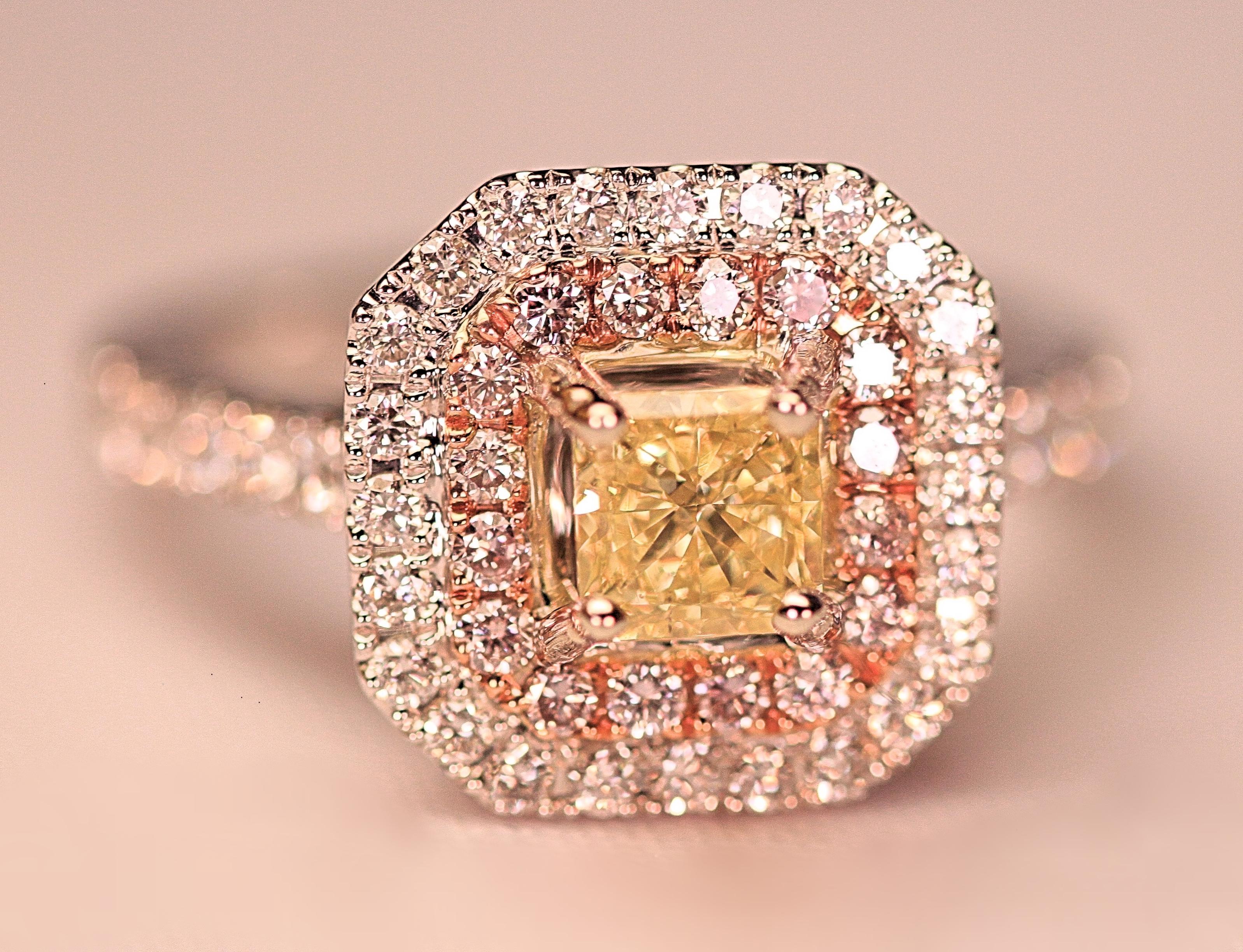 The ring that has a GIA certificate on the center radiant cut diamond. The certificate grades the center diamond as a natural fancy intense yellow diamond. The diamond weighs .83 carat total with a clarity grading of VS2. The fancy yellow is
