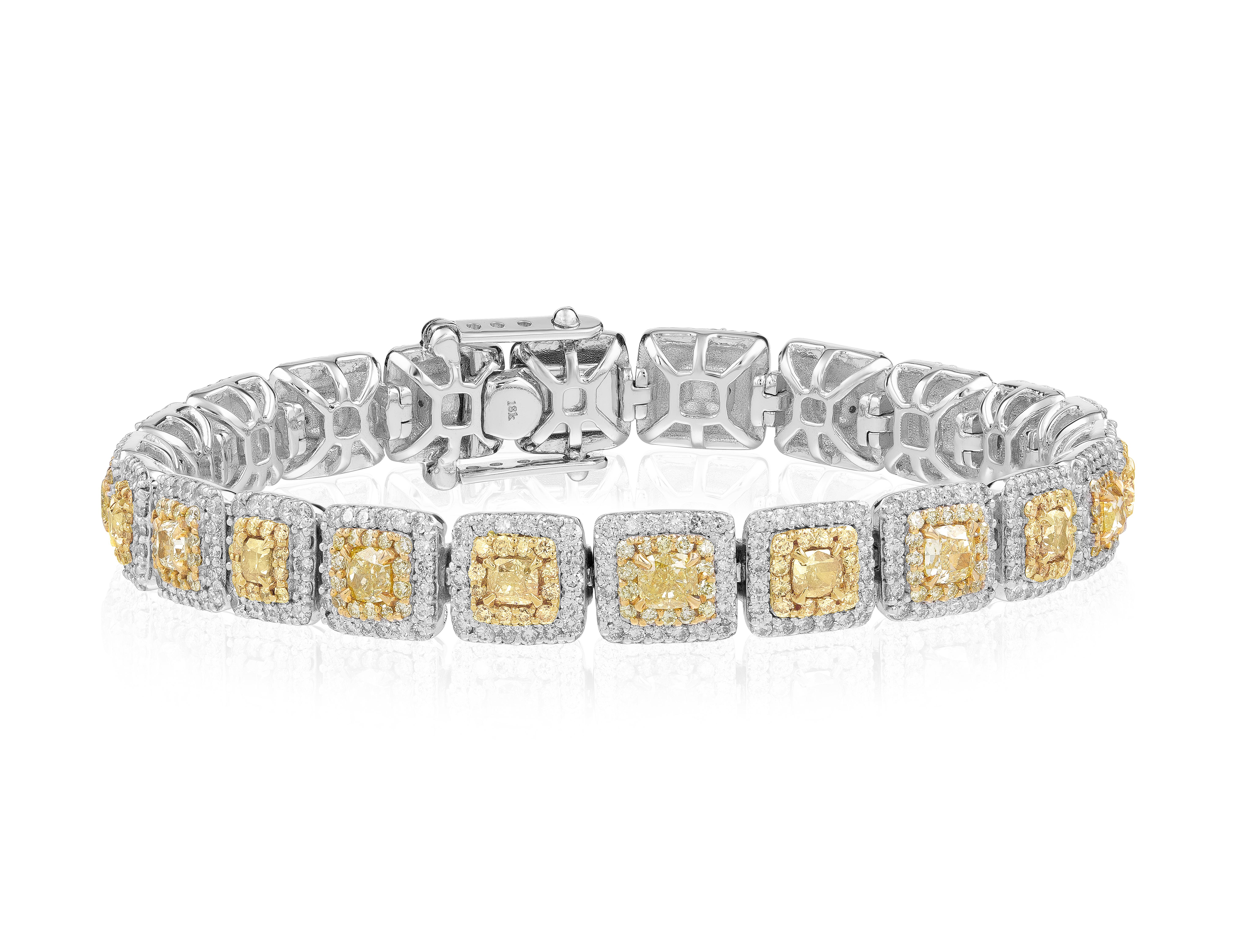 Indulge in the allure of our exquisite fancy yellow diamond bracelet, a truly unique and captivating piece of jewelry. This bracelet features 21 stunning center diamonds, each weighing approximately 4.36 carats, showcasing their vibrant and