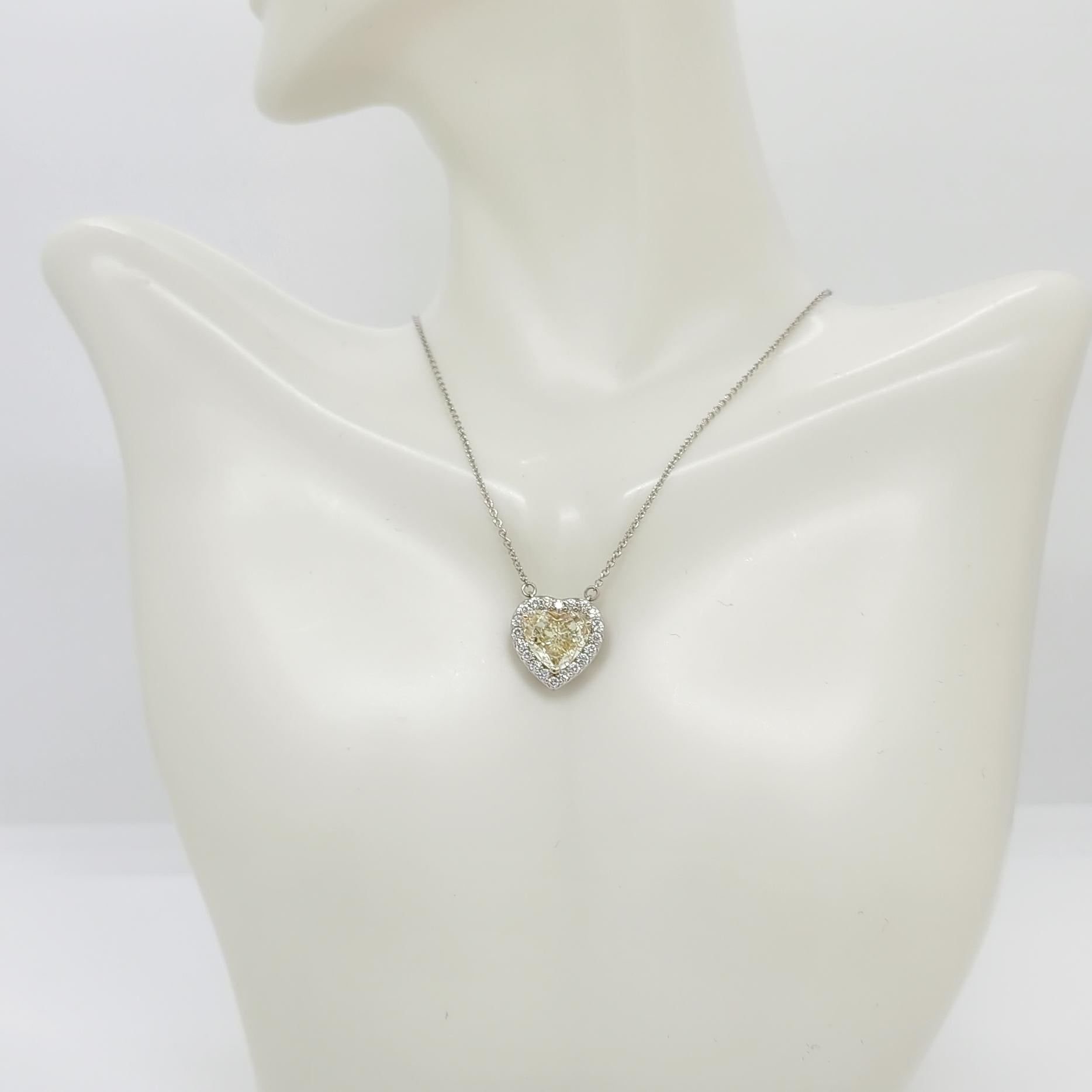 Gorgeous 2.67 ct. yellow diamond heart shape with 0.40 ct. white diamond rounds. Handmade in 18k yellow and white gold.