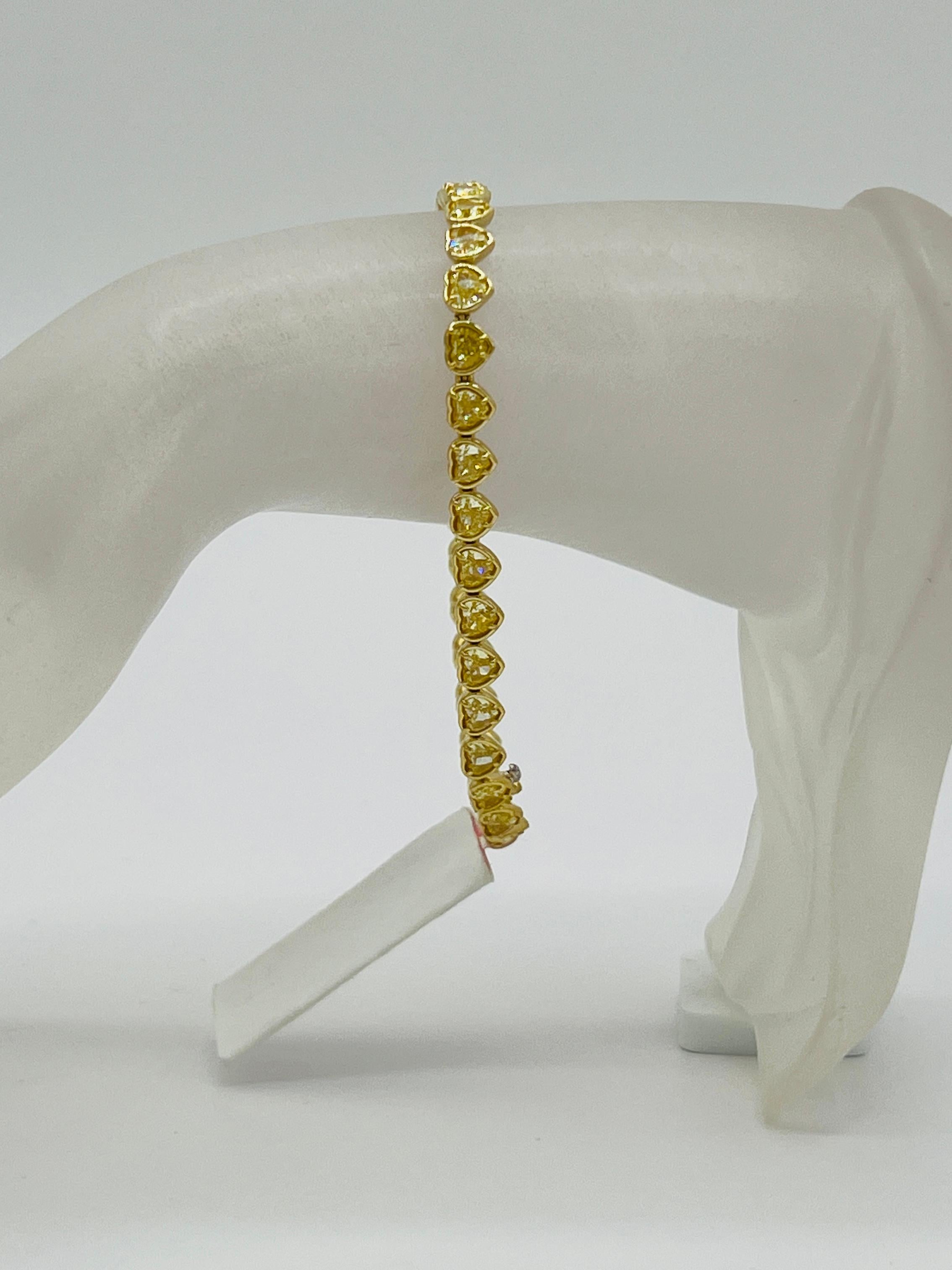 Beautiful 8.87 ct. bright yellow heart shape diamonds.  Total of 34 stones.  Handmade in 18k yellow gold.  Length is 7