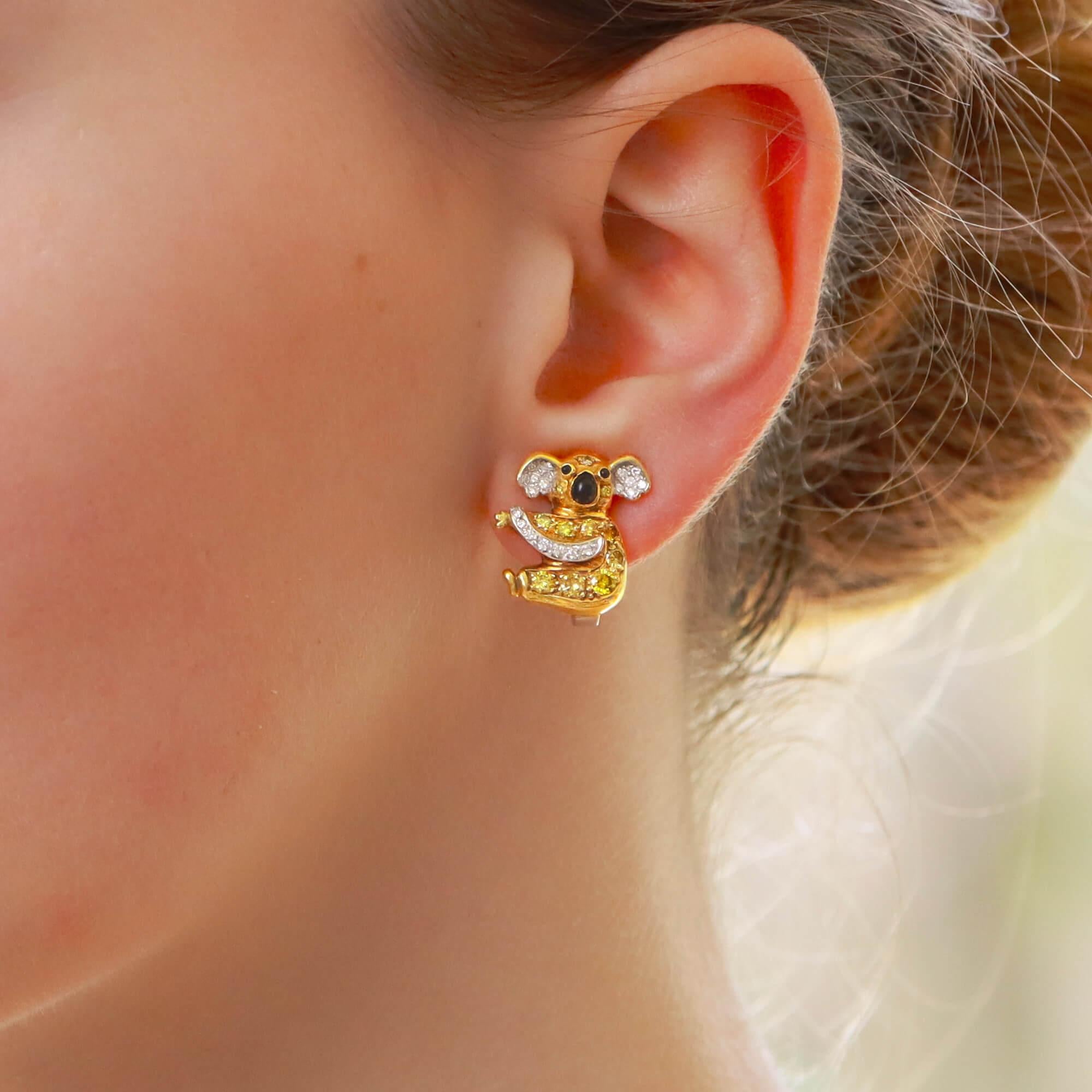 An adorable pair of vintage koala bear yellow and white diamond and onyx stud earrings in 18 karat gold, circa 1980. Each earring is modelled as a koala bear entirely pave-set with round brilliant-cut Fancy Intense to Fancy Vivid Yellow diamonds.