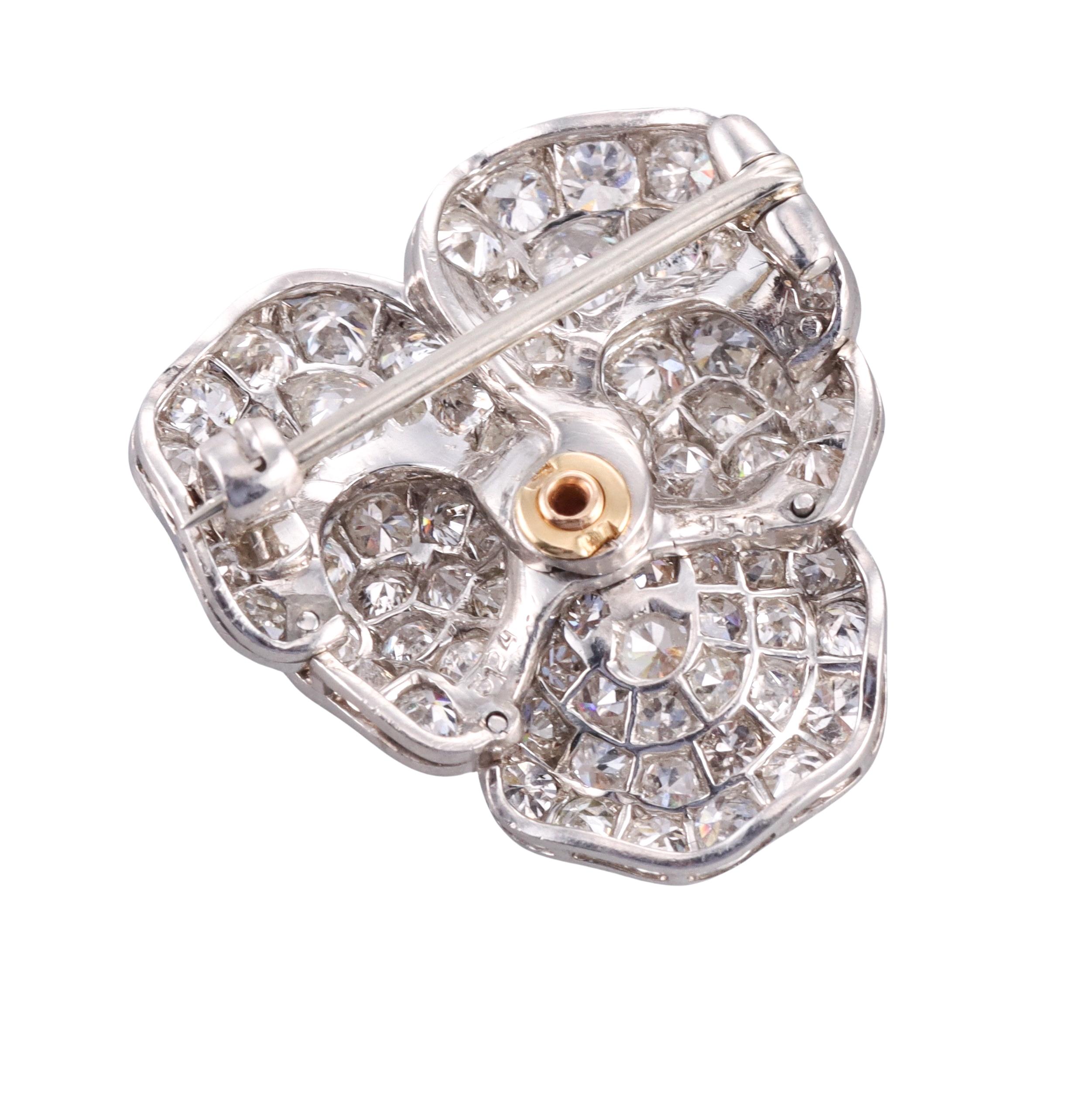 Delicate platinum pansy flower brooch, featuring center oval fancy yellow diamond - approx. 0.40ct, surrounded with five petals , set with a total of approx. 3.40ctw G/VS-Si diamonds. Brooch measures 1