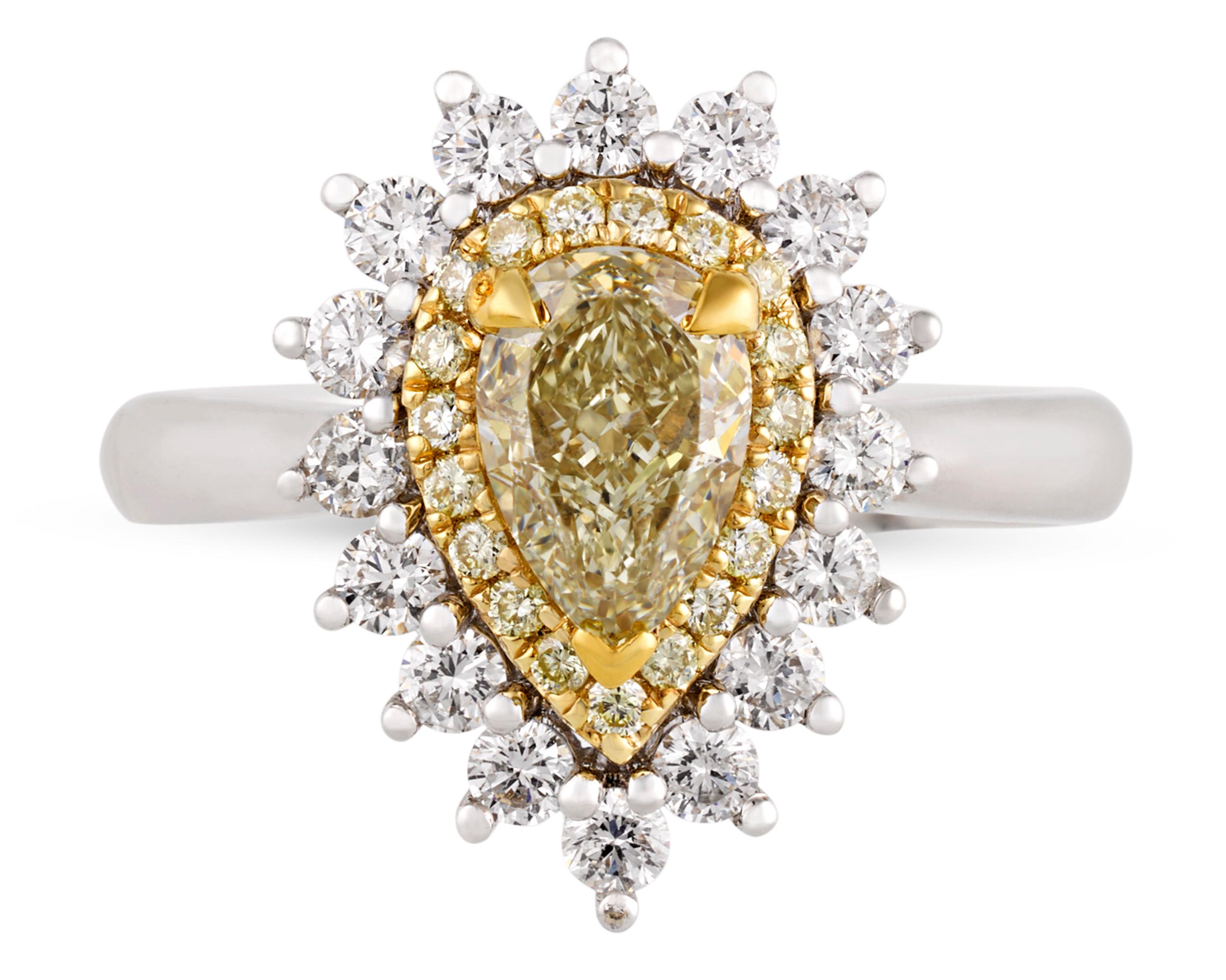 A pear-cut yellow diamond weighing 1.02 carats exudes romantic charm at the center of this ring. The vibrant stone is surrounded by a double halo of white diamonds totaling 0.74 carat for added sparkle and drama, combining stunning brilliance with