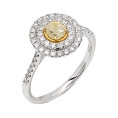 Anello con diamante giallo di forma rotonda in oro bianco 18k