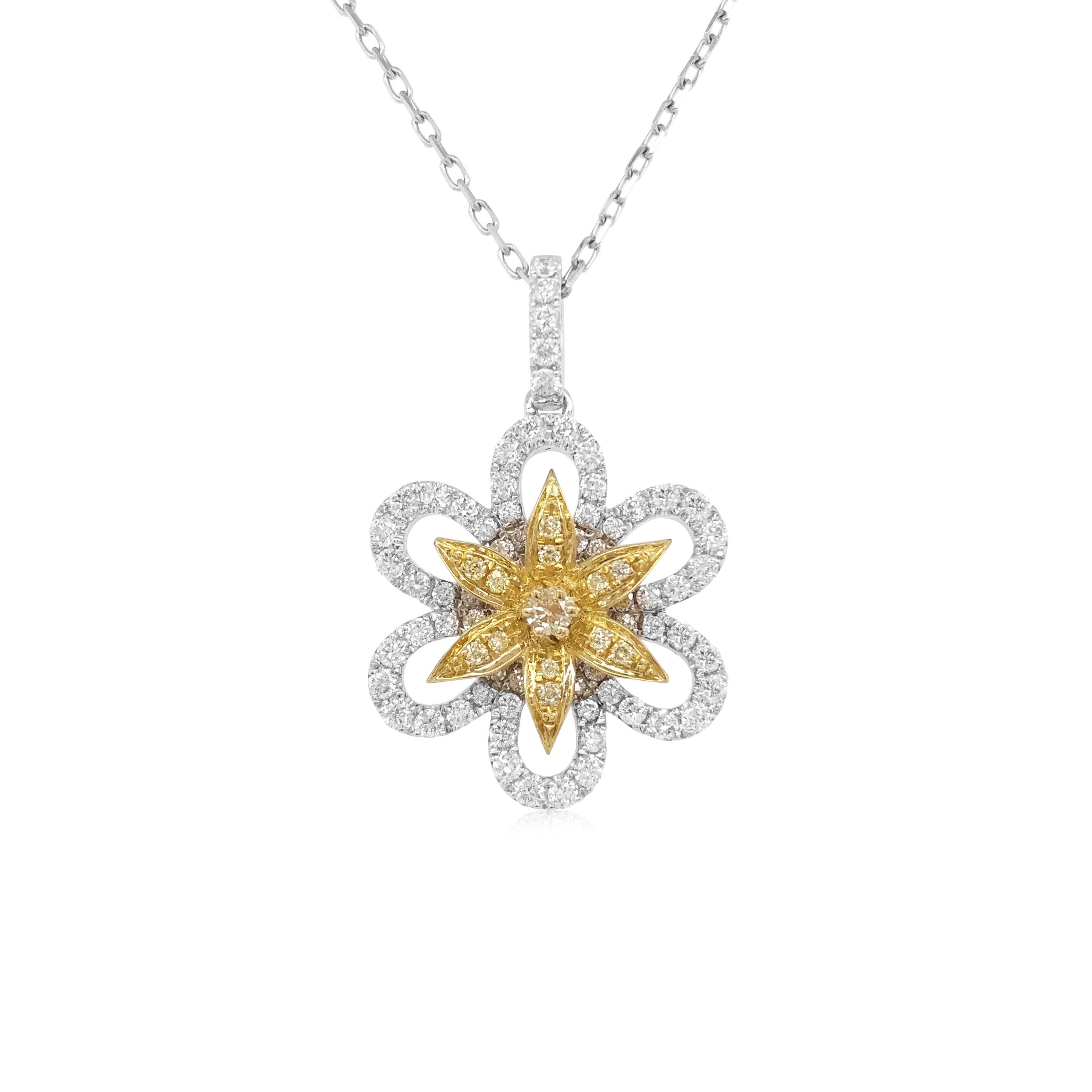 Ce pendentif floral unique présente en son centre de saisissants diamants jaunes naturels, entourés d'un motif audacieux de diamants blancs étincelants. Pièce parfaite pour passer du jour au soir, ce pendentif rehaussera n'importe quelle tenue,