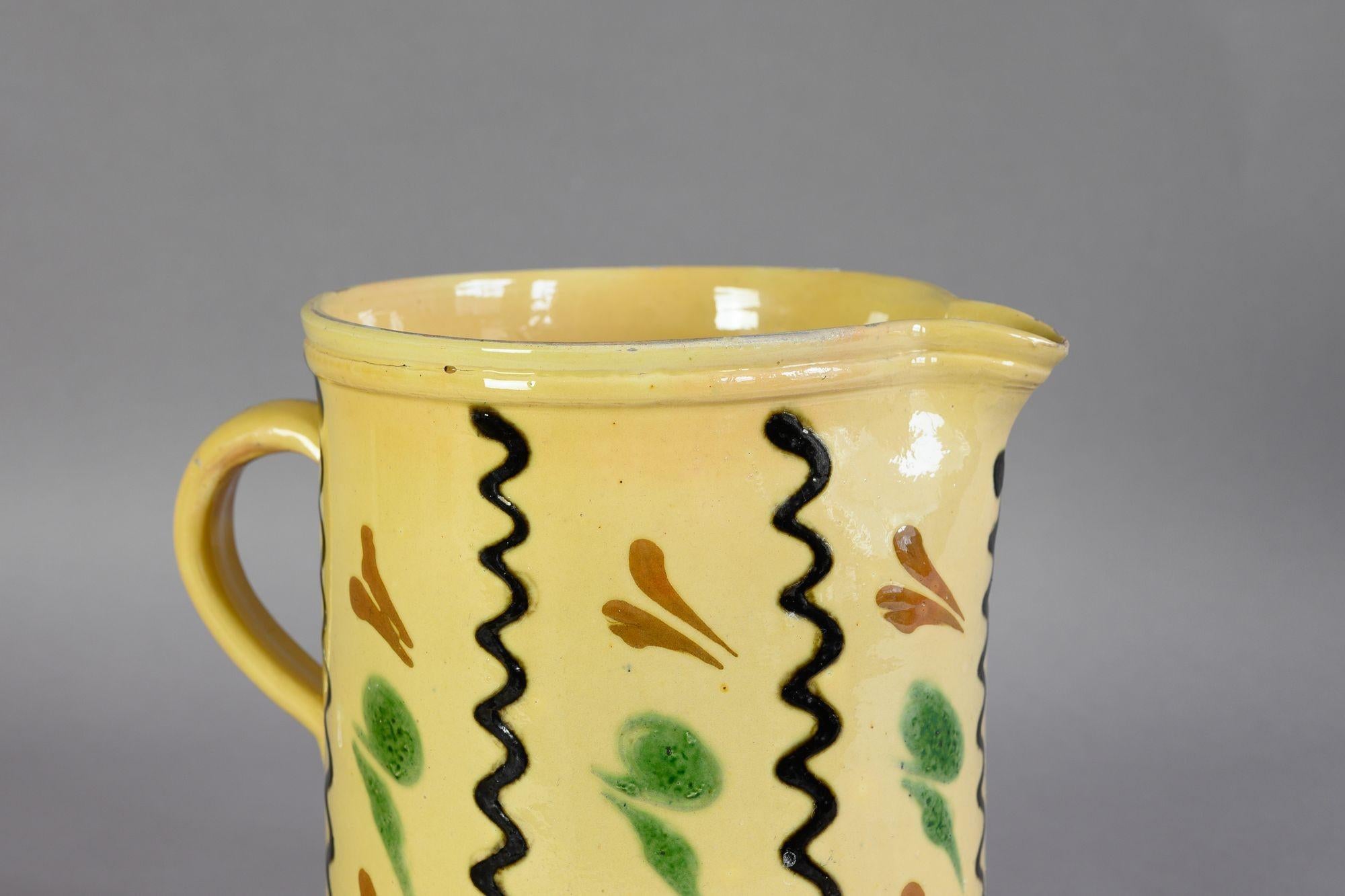 Yellow glazed earthenware jug with simple decoration. Circa 1900
H 19cm x W 21cm x D 16cm