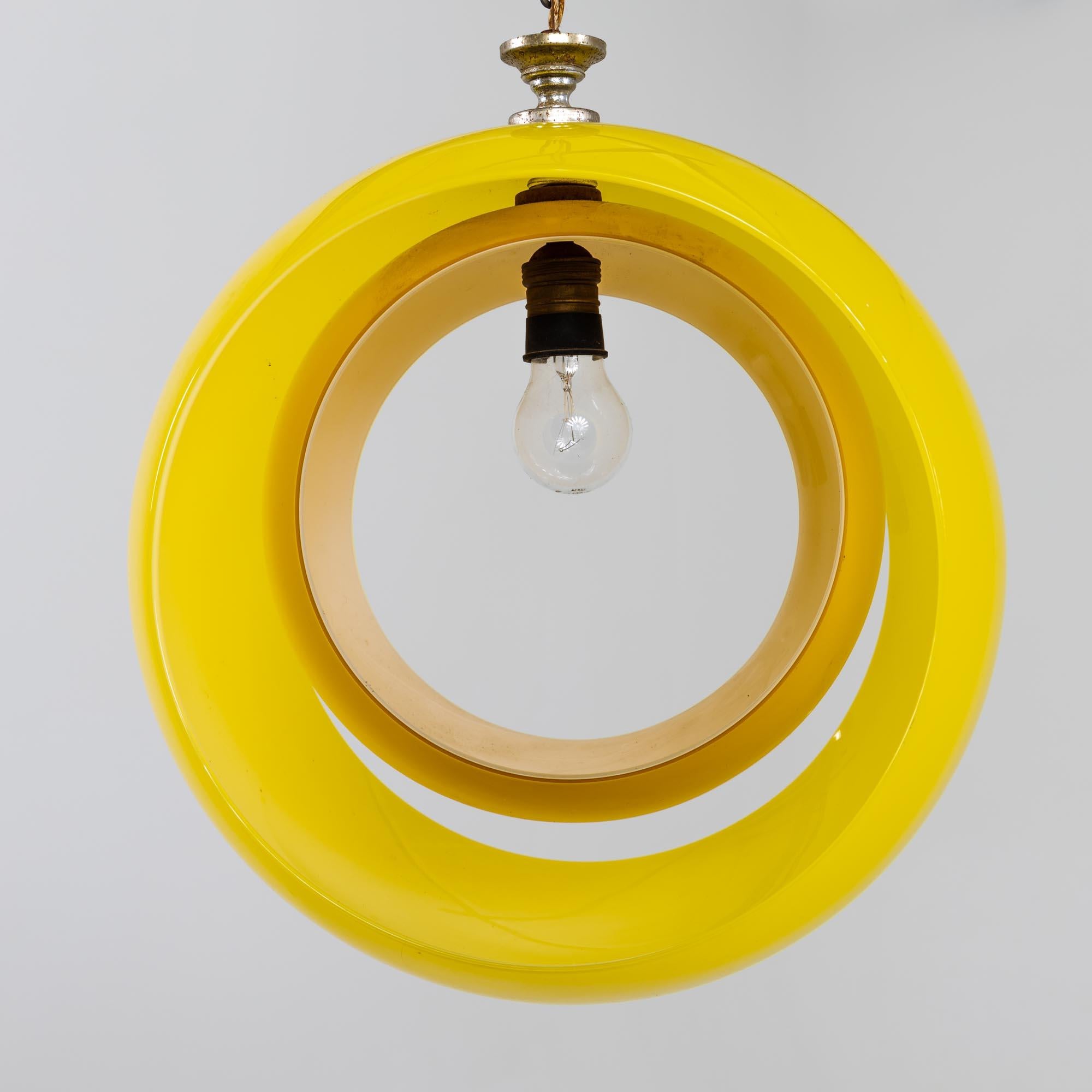 Hängelampe aus gelbem Muranoglas, entworfen von Carlo Nason für Mazzega in den 1960er Jahren. Die Leuchte besteht aus zwei Glasbügeln, die nach Belieben gedreht werden können, so dass die einzelne Glühbirne auch komplett verdeckt werden kann. Länge