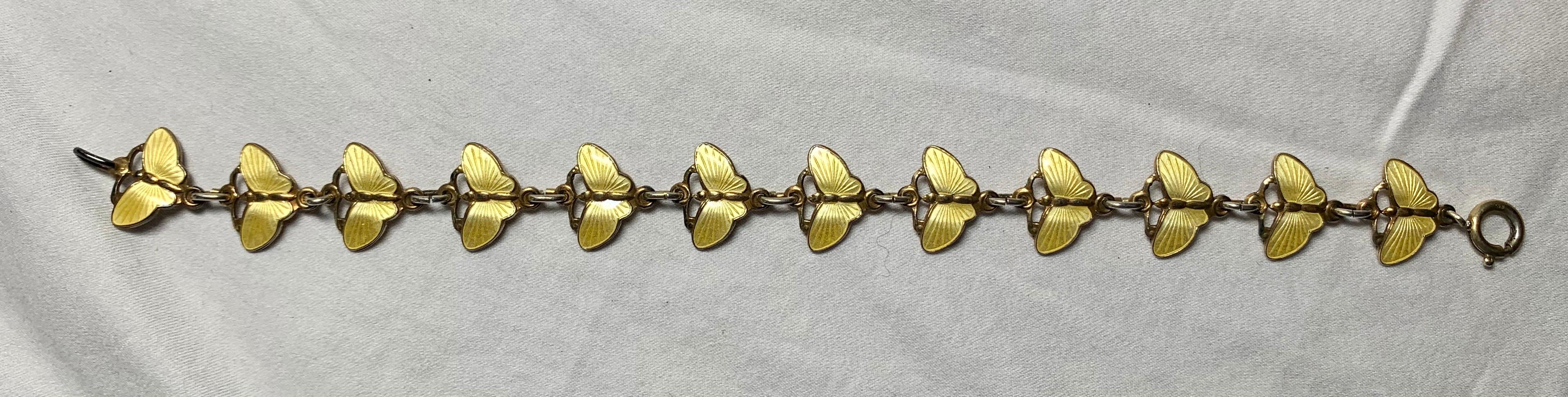 An exquisite Mid-Century Modern Eames Era Yellow Enamel Butterfly Bracelet from Norway in Sterling Silver.  The markers mark may be either Tone Vigeland or Finn Jensen.  The butterflies are in an incredible yellow guilloche enamel design.  This