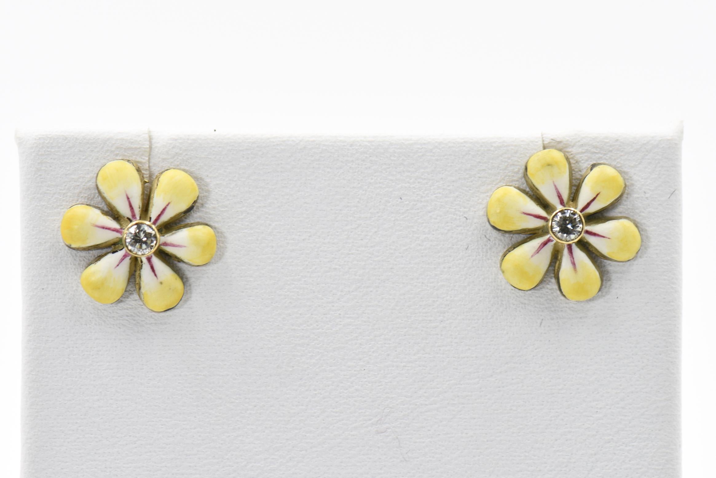 This pair of yellow enamel daisy earrings are part of the daisy line, a beautiful handmade line of jewelry by Sandra J. Sensations. Each flower is hand painted by an enamel artist. The flowers are 14k with diamonds in the center. Each diamond is