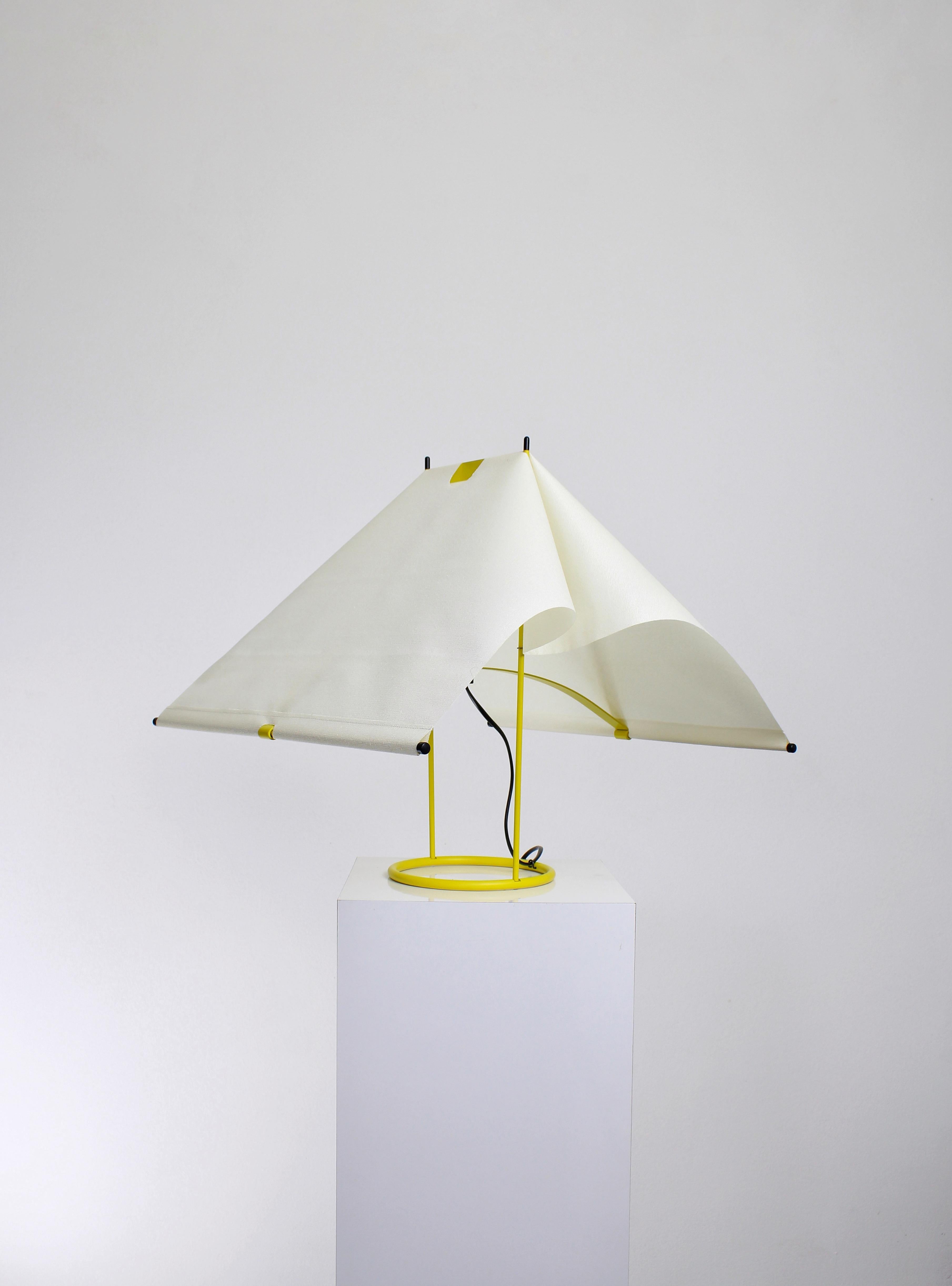 Yellow table lamp, model Falene. Produced by Arteluce circa 1980s. The designer Piero De Martini is an architect who spent most of his career working for Cassina. The Falene is made of yellow lacquered steel and a crème fabric shade, it looks like a