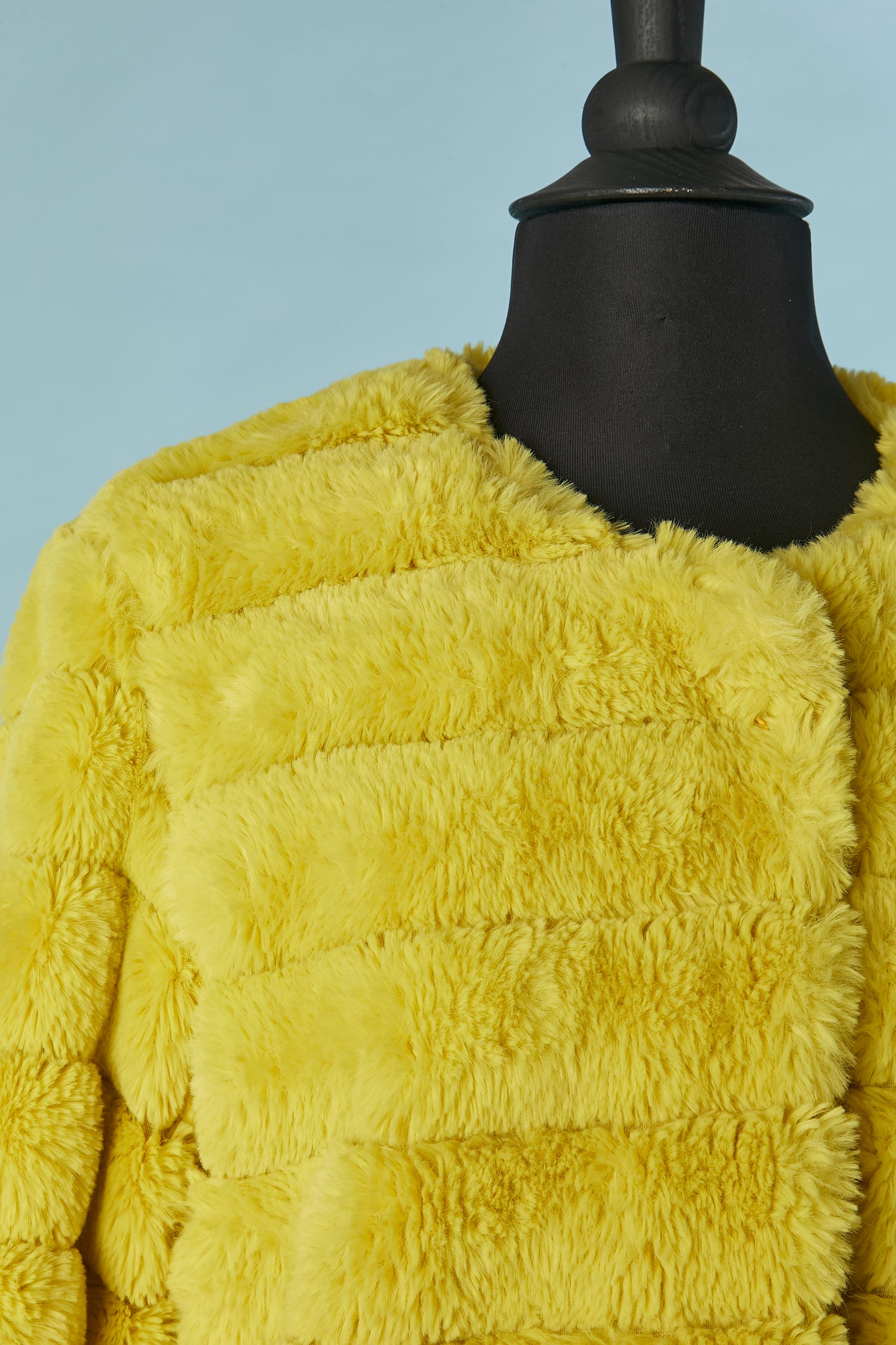 Yellow faux fur edge to edge coat with laser cut and pocket on both side . The fabric composition tag has been cut but the main fabric is polyester and the lining is probably rayon. 
SIZE S on tag but fit more likely M 