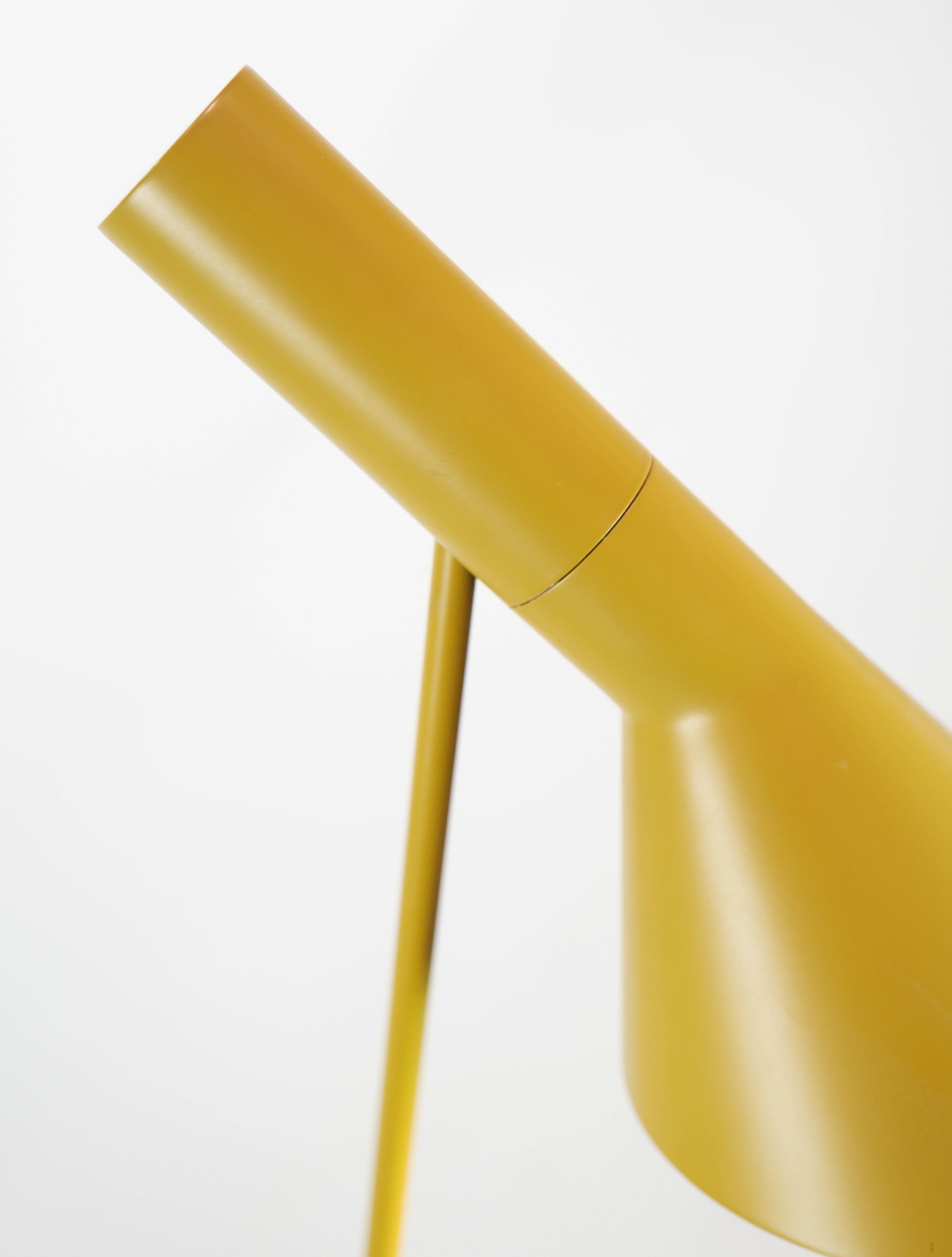 Yellow floor lamp designed by Arne Jacobsen and manufactured by Louis Poulsen. The lamp was originally designed for the SAS Royal Hotel in Copenhagen in 1957 for the hotel's design concept. The lamp here is the original made of steel with a tiltable