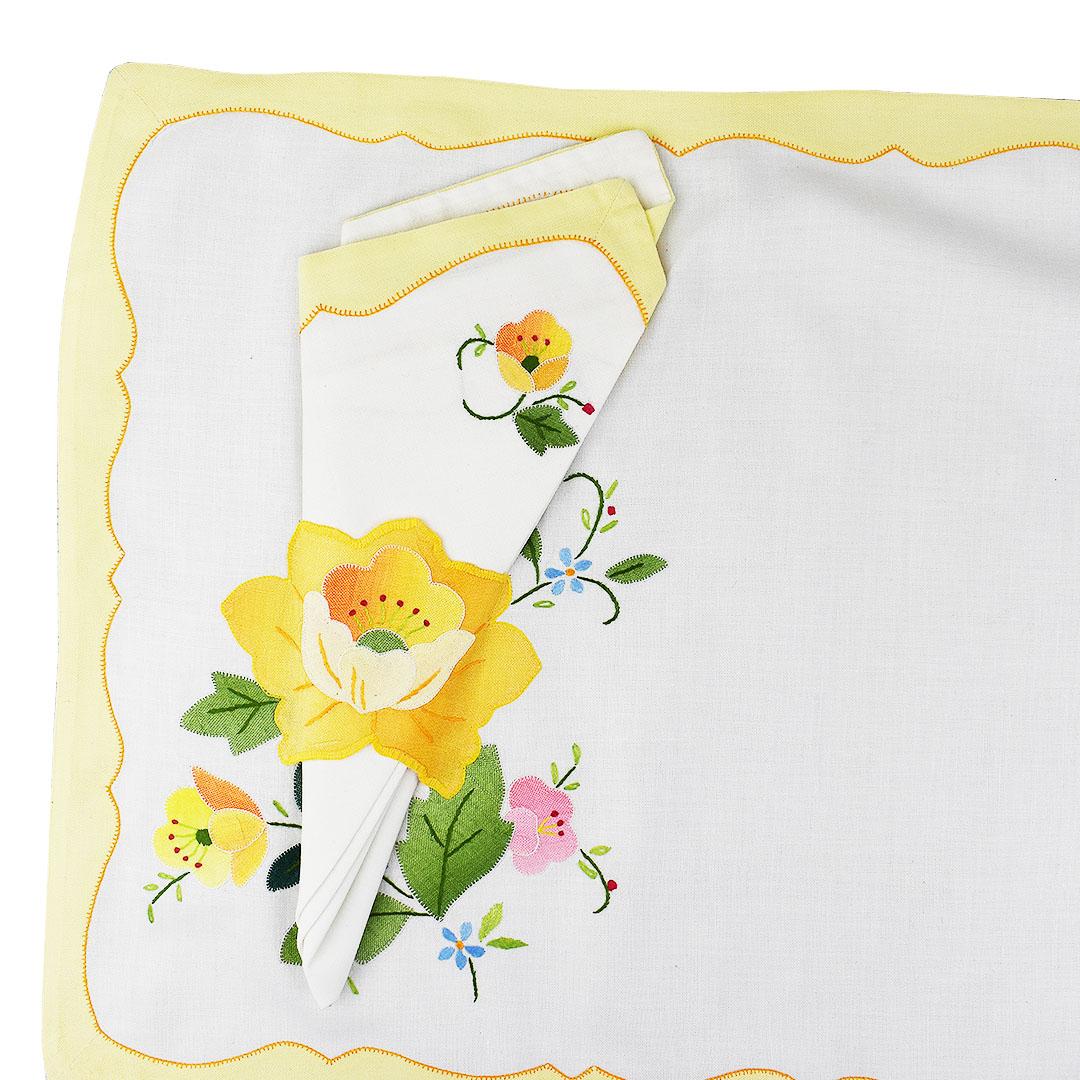 Set of six floral pale yellow cloth placemats and 5 matching napkins. A wonderful accent to a table setting, each set includes one placemat with a matching napkin. A light yellow scalloped edge lines the outside of each placemat. At the bottom left,