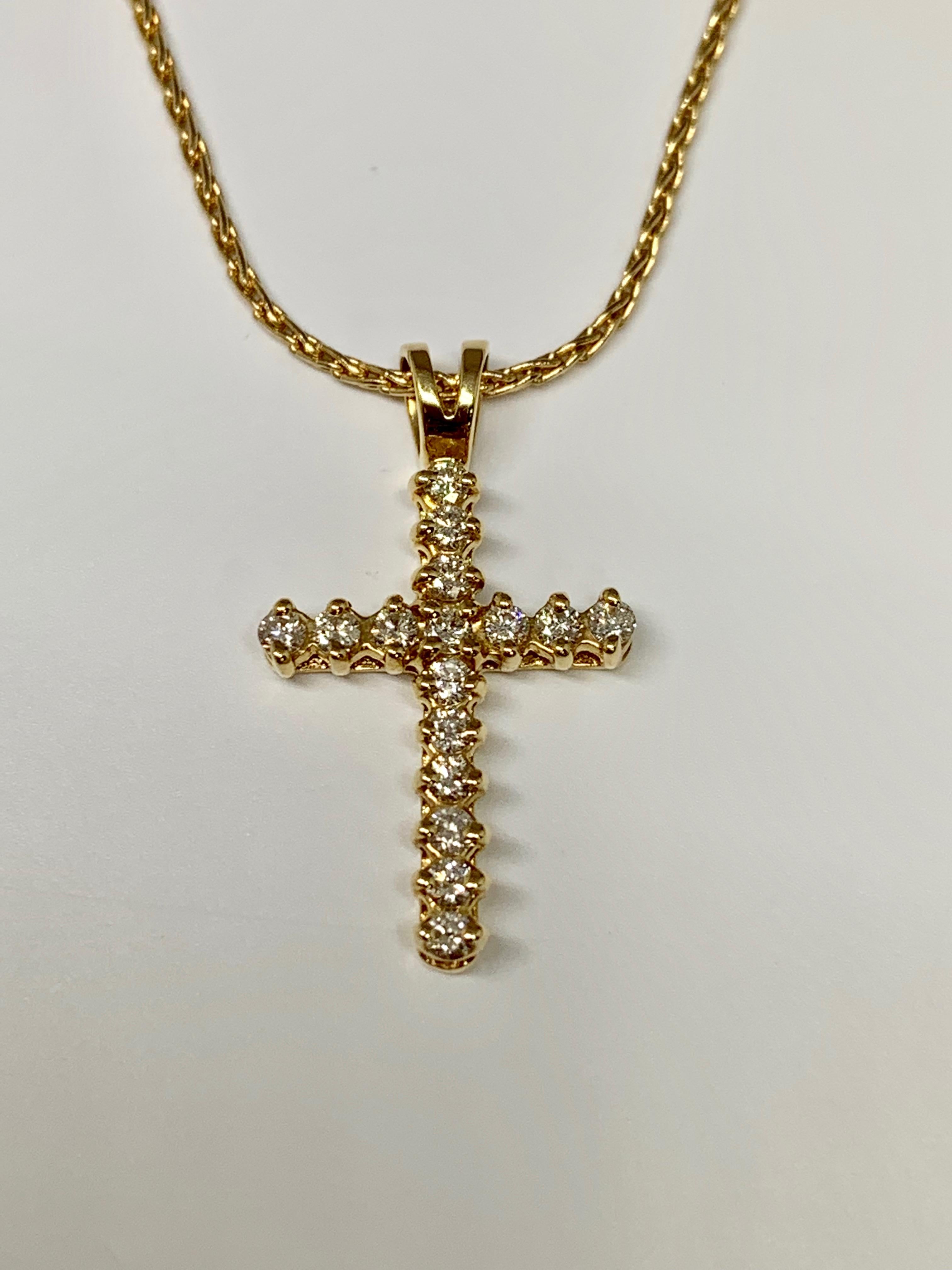 This classic cross pendant is made of 14K yellow gold and features 0.25 carats of round white diamonds. This necklace includes an 18 inch wheat style chain with a sturdy lobster claw clasp. 