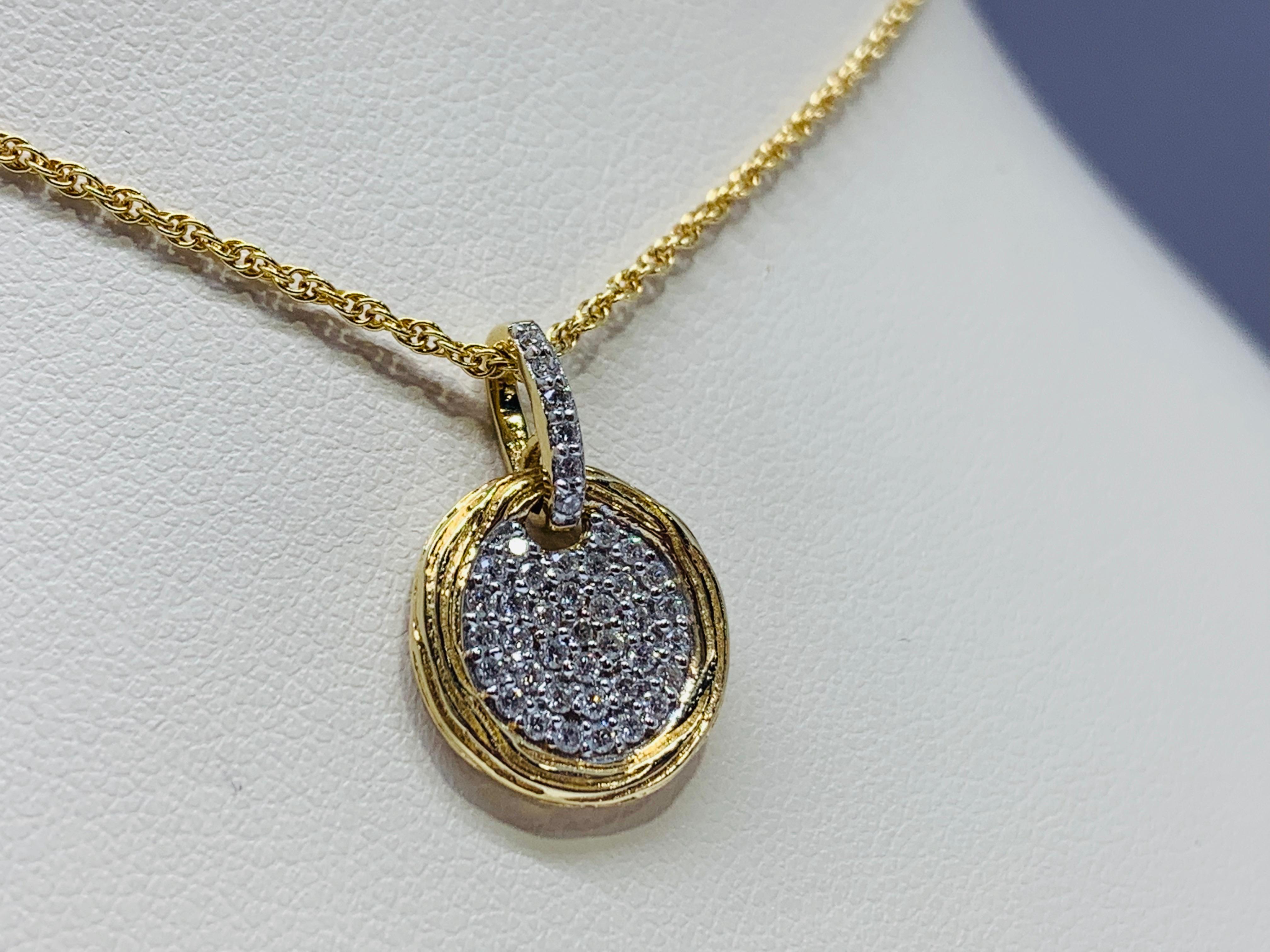 This stunning necklaces is made out of 14k yellow gold and holds a total round diamond weight of 0.25 carats. This necklace includes a sturdy 18 inch rope chain with a secure lobster claw clasp. The pendant itself is 0.5 inches wide and the chain is