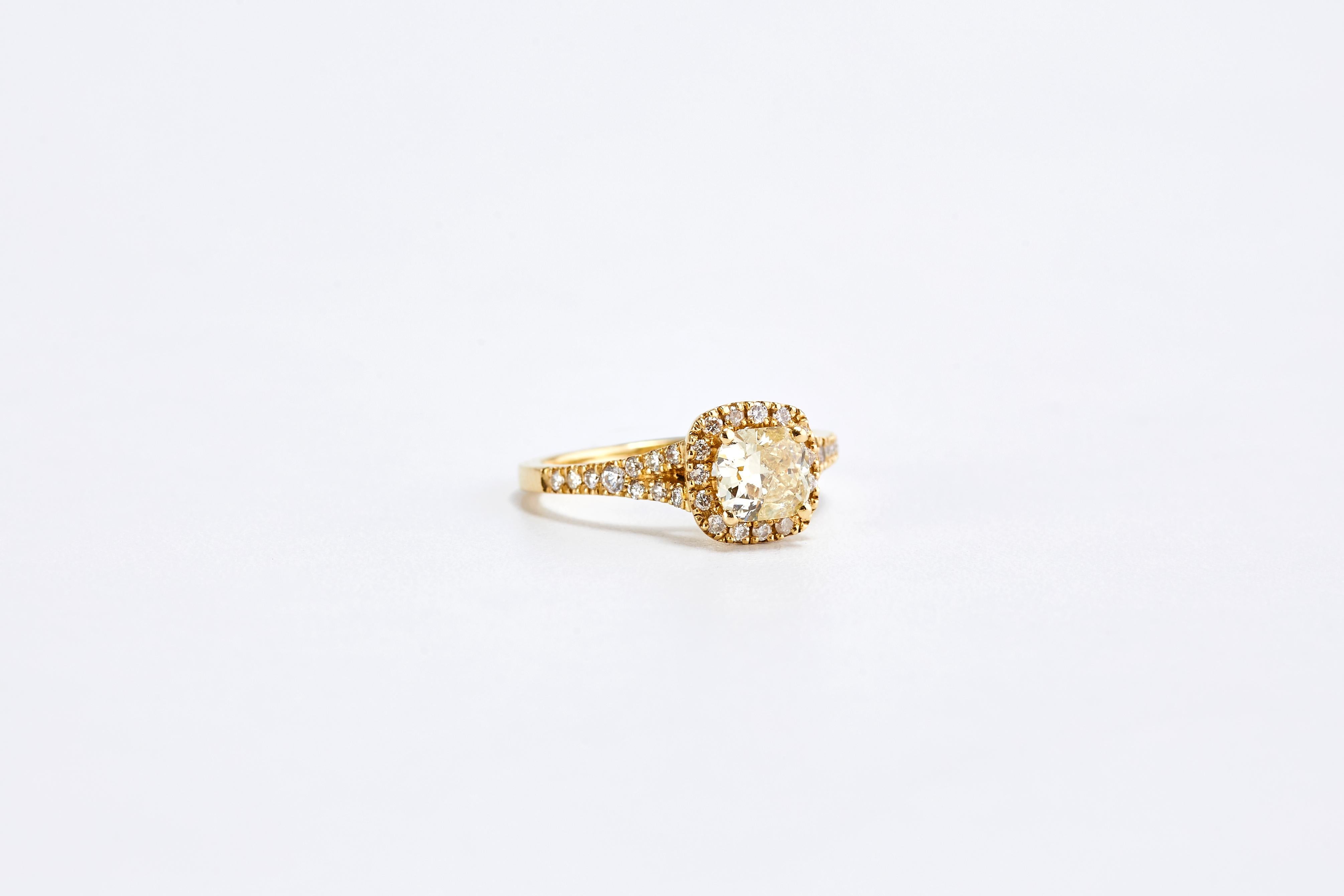 Yellow Gold 0.90 Carat Fancy Yellow Cushion Diamond Engagement Ring with a Halo 

Stunning and fashionable design of a fancy yellow diamond engagement ring.
14 karat yellow gold.
0.90 carat Center diamond fancy yellow color. Diamonds halo and pave