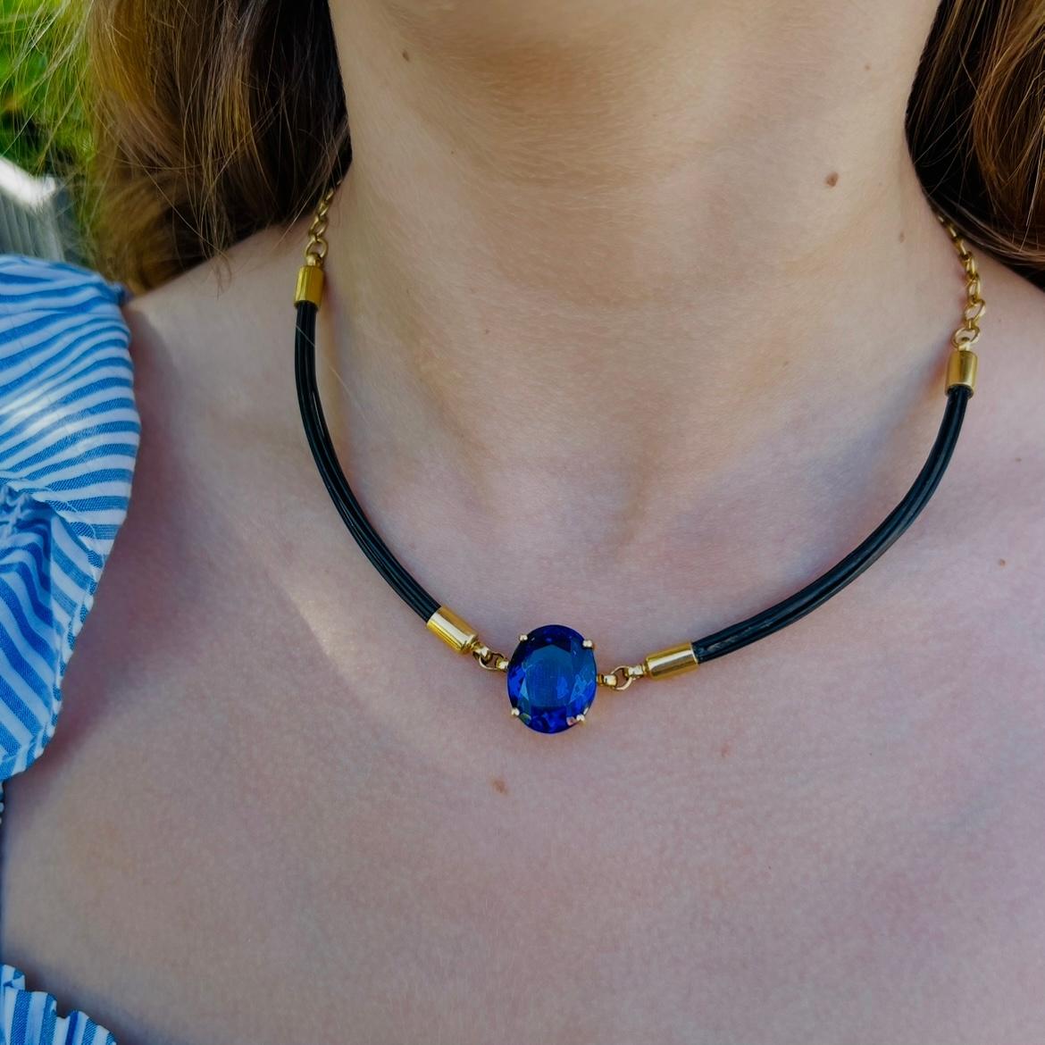 Purchased in Tanzania, this unique estate piece features a tanzanite that is bound to turn heads! With a near perfect blue color that has the slightest hints of purple undertones, this truly special stone is expertly showcased in this well-designed