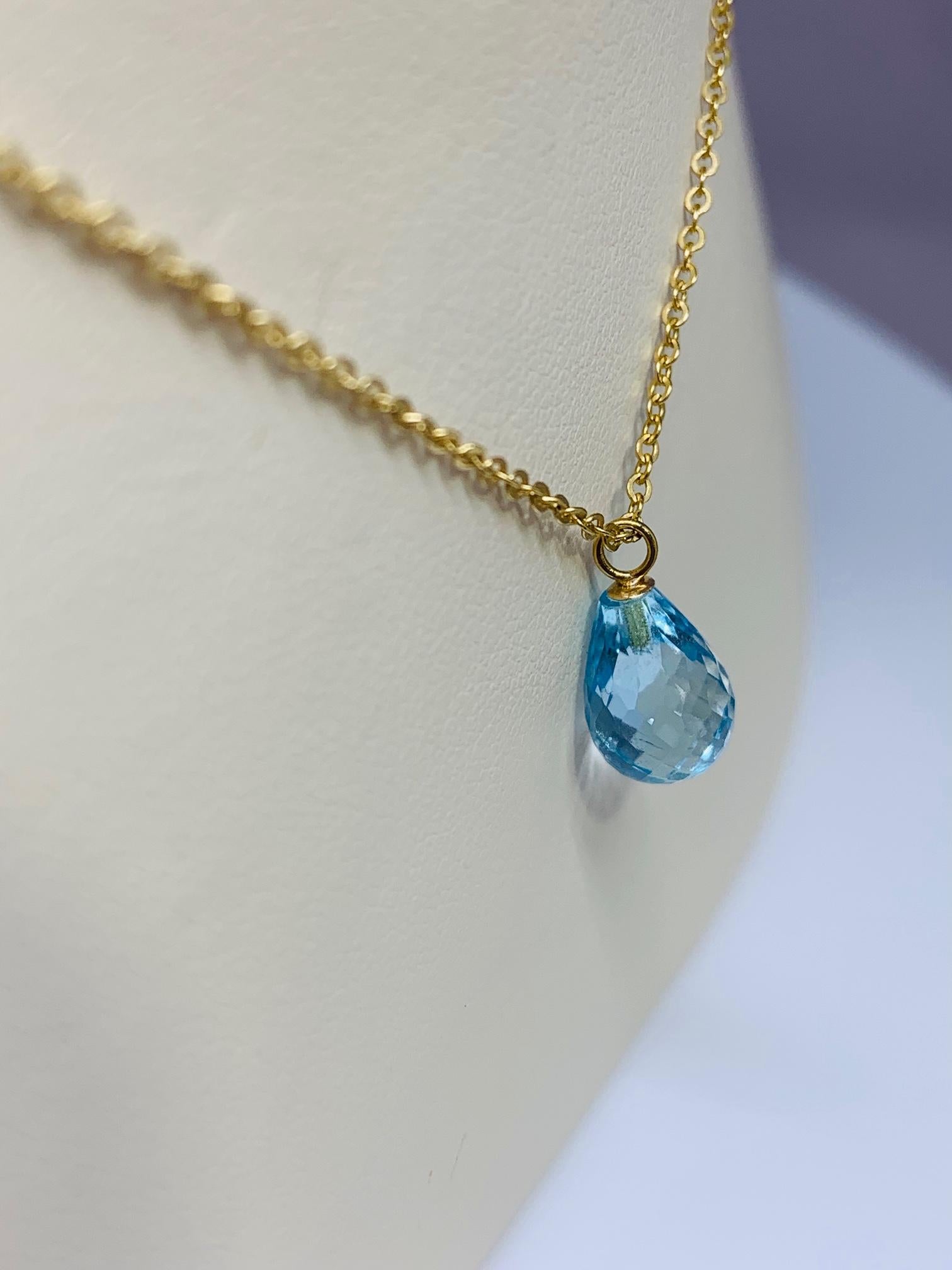 This stunning necklace is the perfect everyday accessory! This necklace is made of 14K yellow gold and features a beautifully faceted 10 x 7 millimeter briolette cut blue topaz! This necklace includes a 17