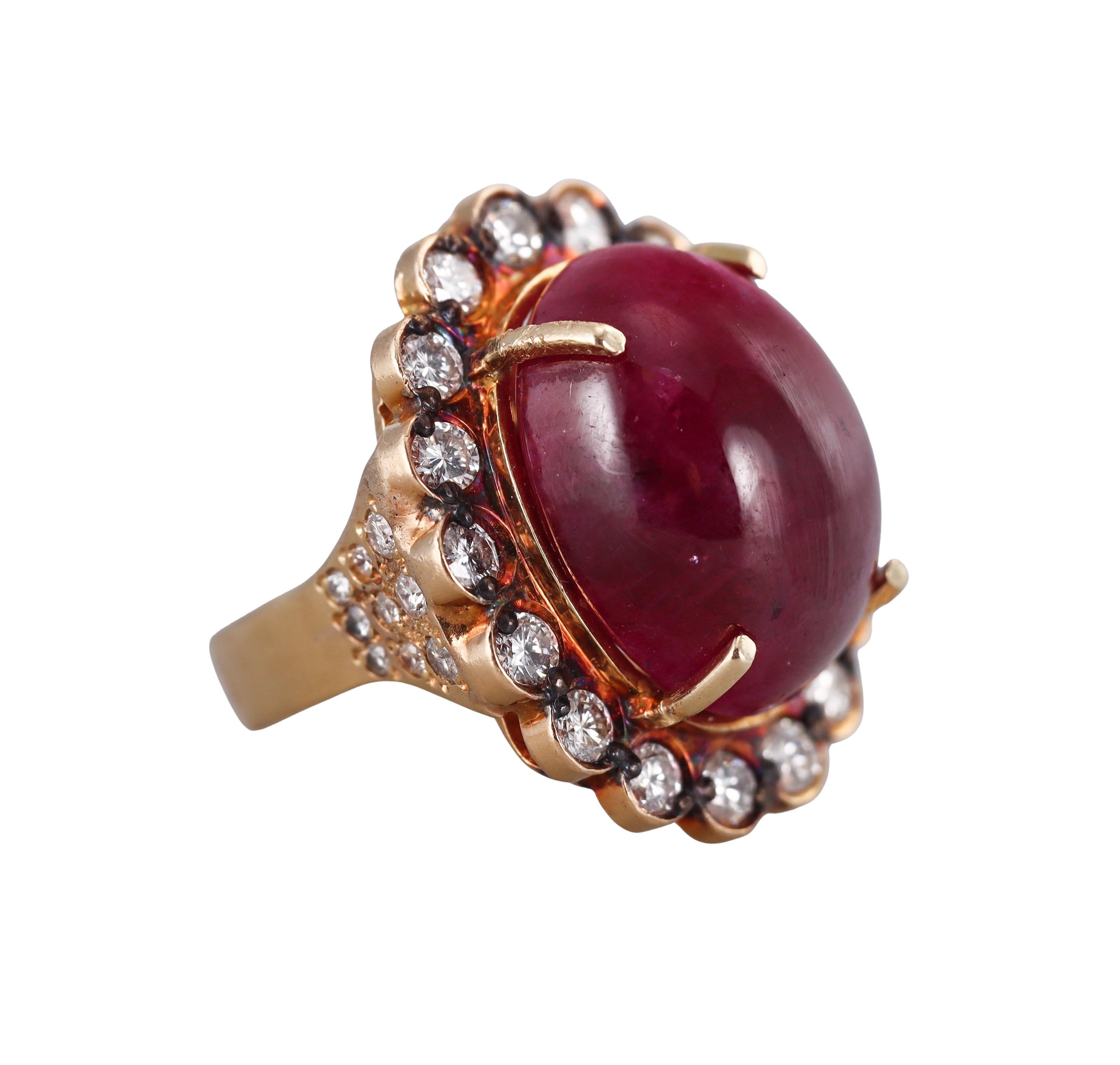An 18k yellow gold cocktail ring, with center approx. 36 carat ruby (measures approx. 21.1 x 16.6 x9.4mm), surrounded with approx. 2.50ctw in diamonds.
Ring size 8.25, top is 30mm x 25mm.
Tested 18k.
Weight - 26 grams.