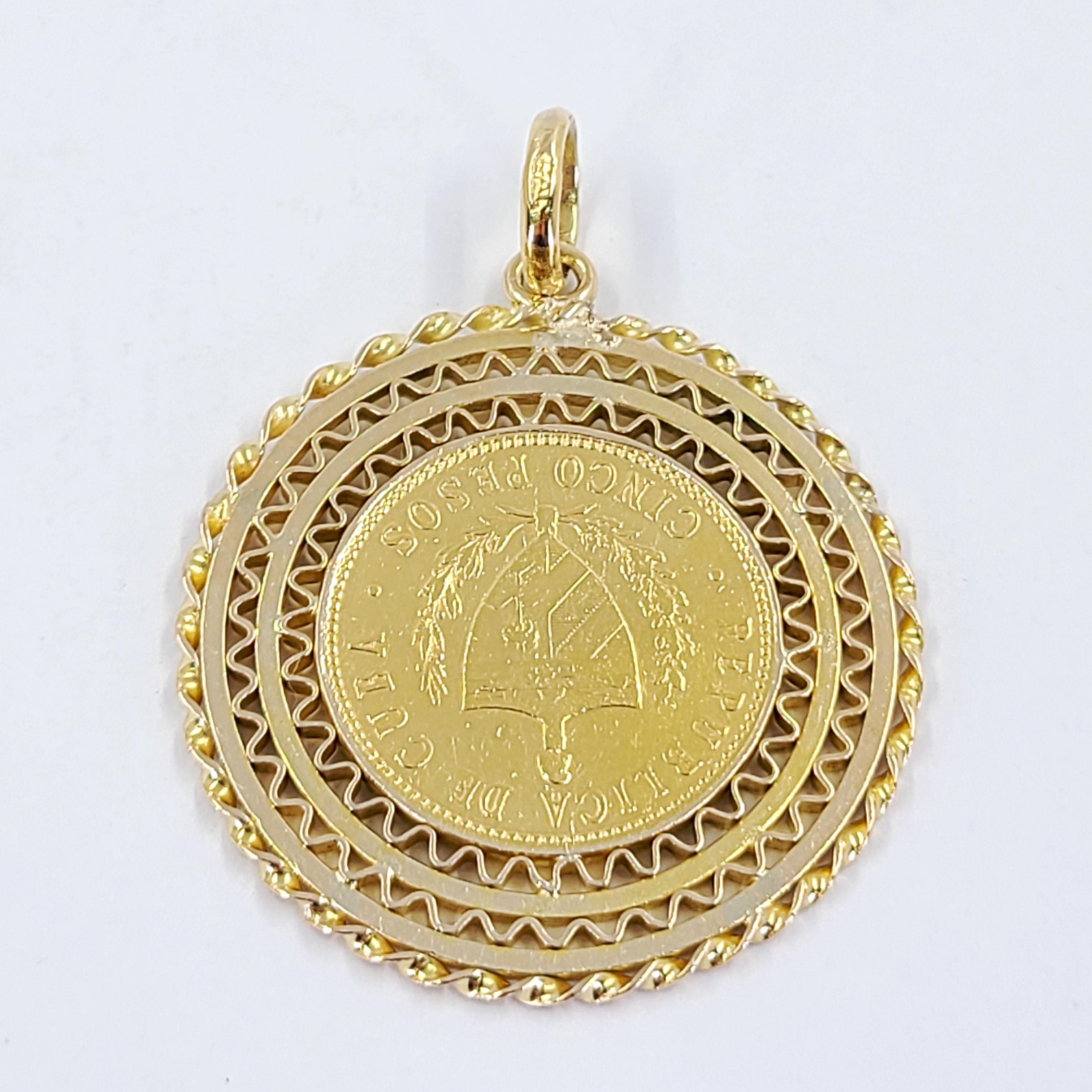 22 Karat Yellow Gold Cuban 5 Peso Coin From 1916 Set In An Ornate 18 Karat Yellow Gold Bezel With Flexible Jump Ring Attachment To Slide Through A Chain. Finished Weight Is 14.6 Grams.