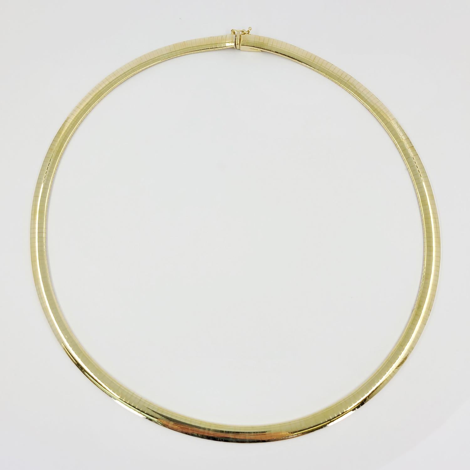 14 Karat Yellow Gold 6mm Wide Omega Necklace With High Polish Finish. Measuring 18 Inches Long. Great For Layering With Longer Yellow Gold Chains. Box Clasp With Figure 8 Safety. Finished Weight Is 41.9 Grams.