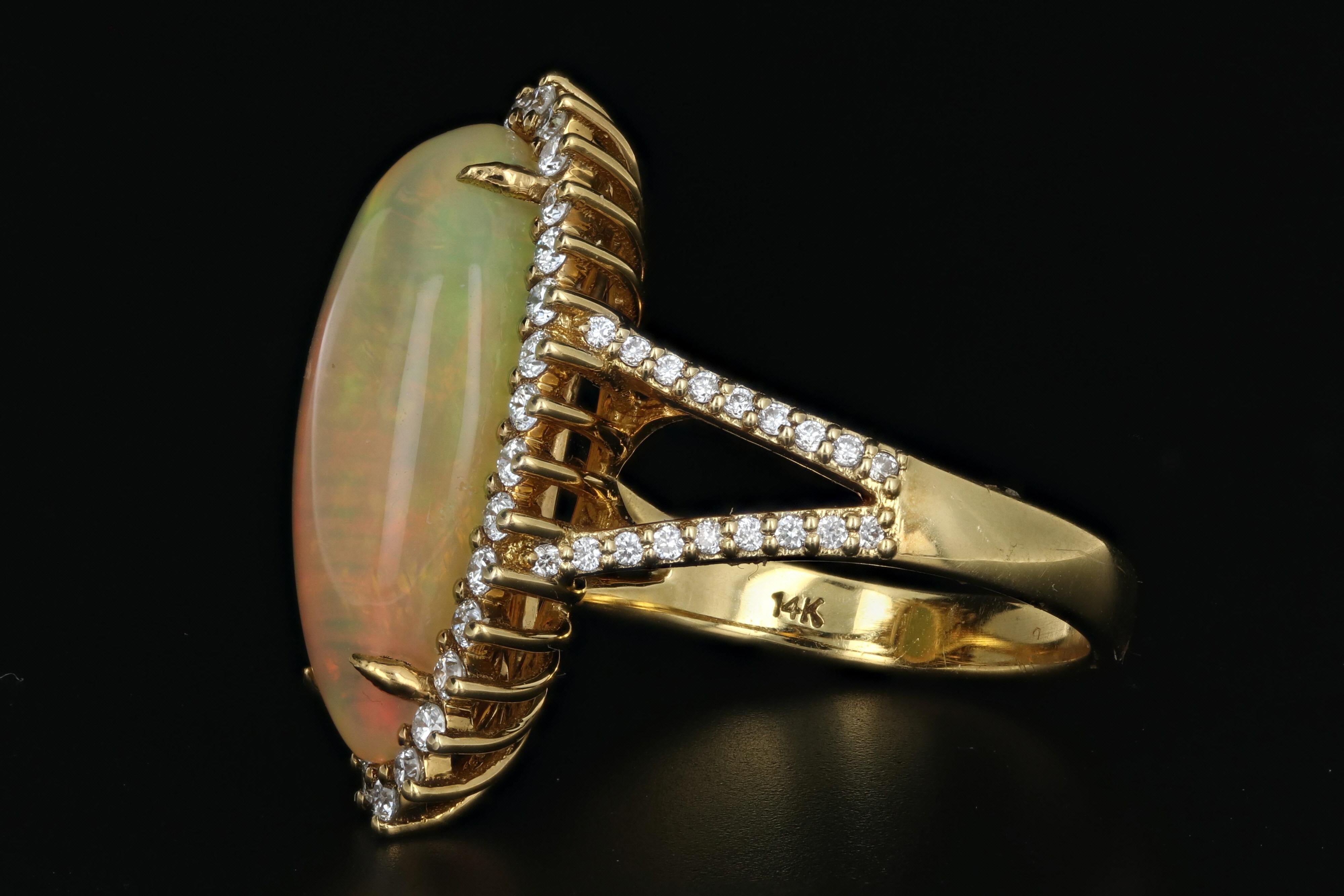 Era: Modern

Hallmarks: 14K

Composition: 14K Yellow Gold

Primary Stone: Ethiopian Opal

Stone Carat: Approximately 8.5 carats

Shape: Tapered Opal Cabochon

Accent Stone: Diamonds

Color/Clarity: G/H - VS1/2

Total Diamond Weight: Approximately