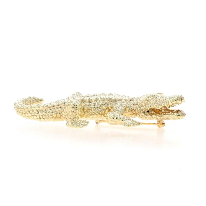 Metal Content: 14k Yellow Gold

Style: Brooch
Fastening Type: Hinged Pin and Whale Tail Bullet Clasp
Theme: Alligator, Reptile
Features: Hollow construction with textured exterior detailing

Measurements

Tall: 1 3/8