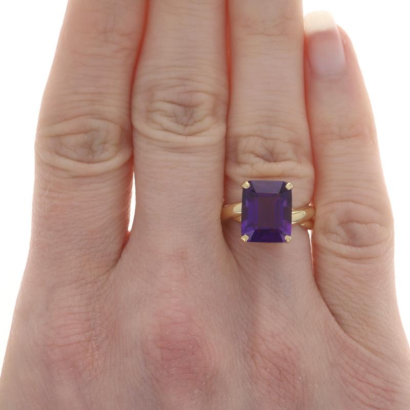 Size: 5 3/4

Metal Content: 18k Yellow Gold

Stone Information
Natural Amethyst
Carat(s): 4.50ct
Cut: Emerald
Color: Purple

Total Carats: 4.50ct

Style: Cocktail Solitaire
Features: Twist Design Spanning the Entire Band's