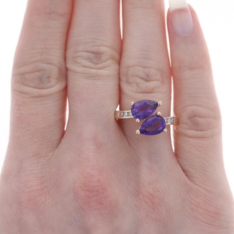 Yellow Gold Amethyst & Diamond Bypass Ring 14k Pear 2.59ctw Leaves Two-Stone

Stone Information:
Natural Amethysts
Carat(s): 2.50ctw
Cut: Pear
Color: Purple

Natural Diamonds
Carat(s): .09ctw
Cut: Round Brilliant
Color: H - I
Clarity: I1

Total