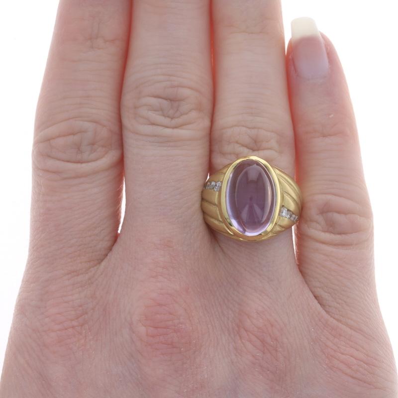 Size: 6 1/2

Metal Content: 18k Yellow Gold

Stone Information

Natural Amethyst
Carat(s): 10.70ct
Cut: Oval Cabochon
Color: Light Purple

Natural Diamonds
Carat(s): .30ctw
Cut: Round Brilliant
Color: G - H
Clarity: SI1 - SI2

Total Carats: