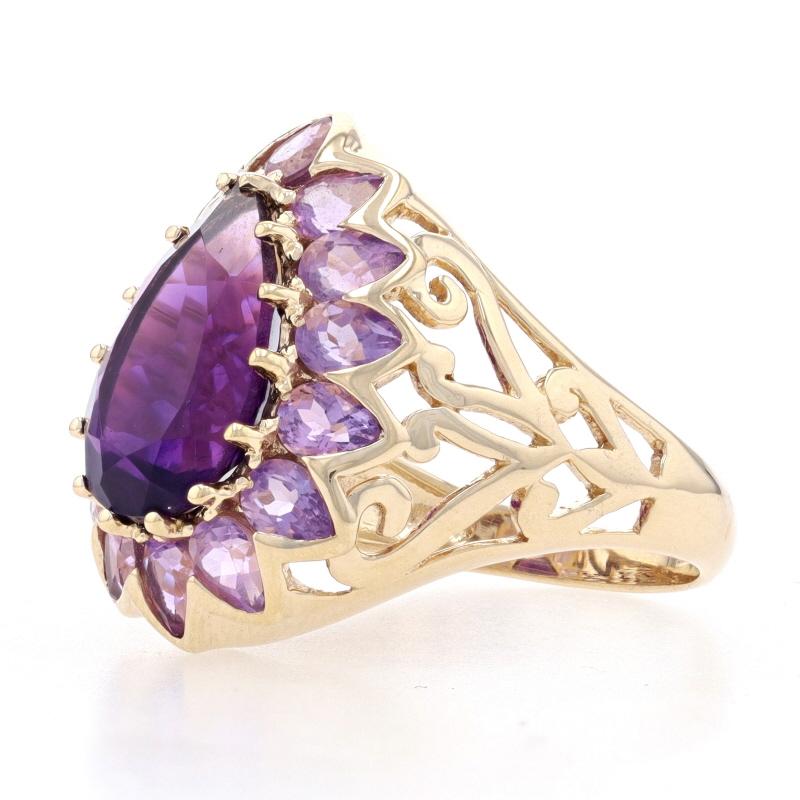 Size: 8 1/4

Metal Content: 10k Yellow Gold

Stone Information
Genuine Amethyst
Carat: 5.00ct
Cut: Pear
Color: Dark Purple

Genuine Amethysts
Carats: 2.10ctw
Cut: Pear
Color: Light Purple

Total Carats: 7.10ctw

Style: Halo Solitaire
Theme: Flower