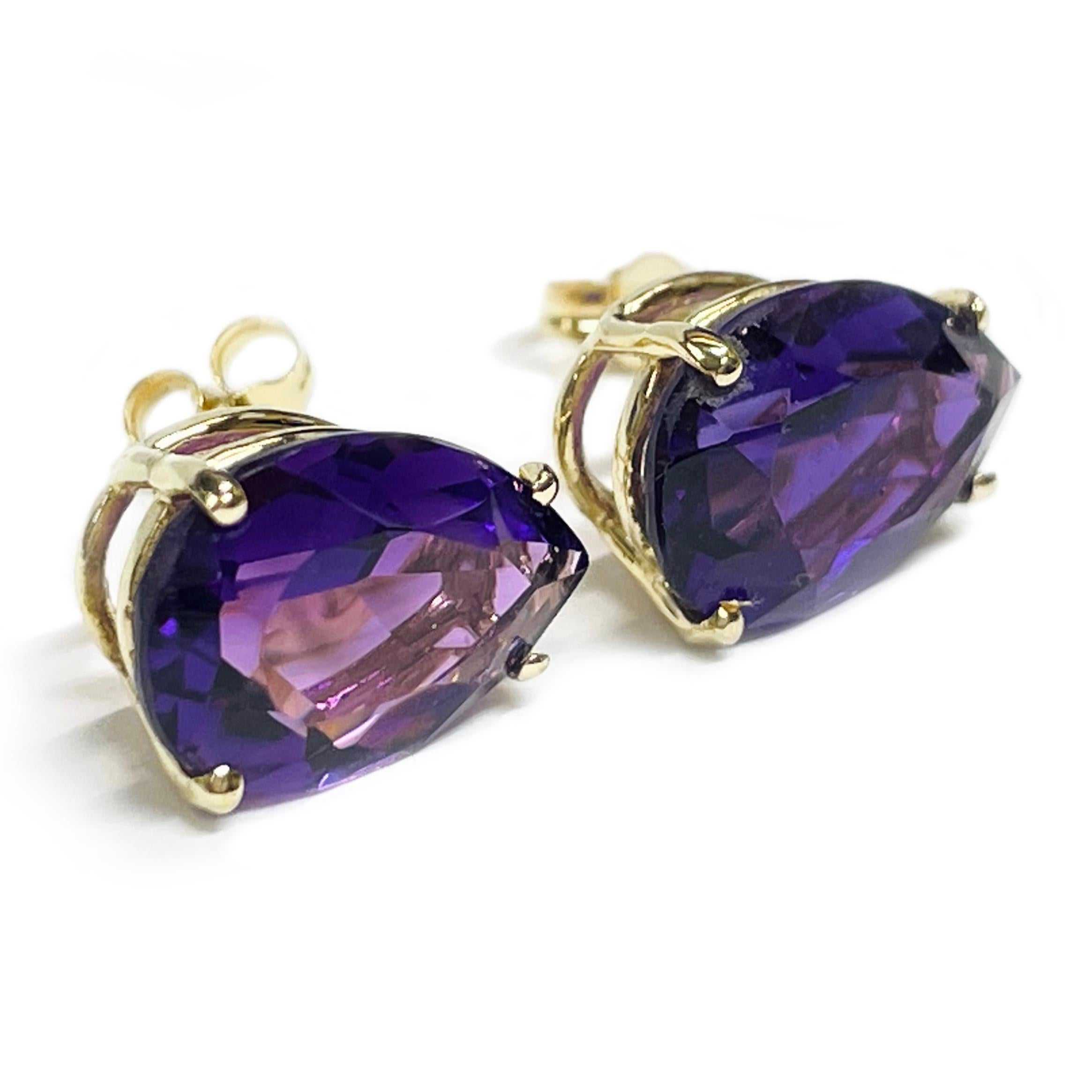 14 Karat Yellow Gold Amethyst Stud Earrings. The earrings each feature a 12 x 8mm pear-shaped Amethyst stone. The medium colored purple gemstones are four-prong-set in a basket setting. The earrings measure 12mm tall and 10mm wide. The total