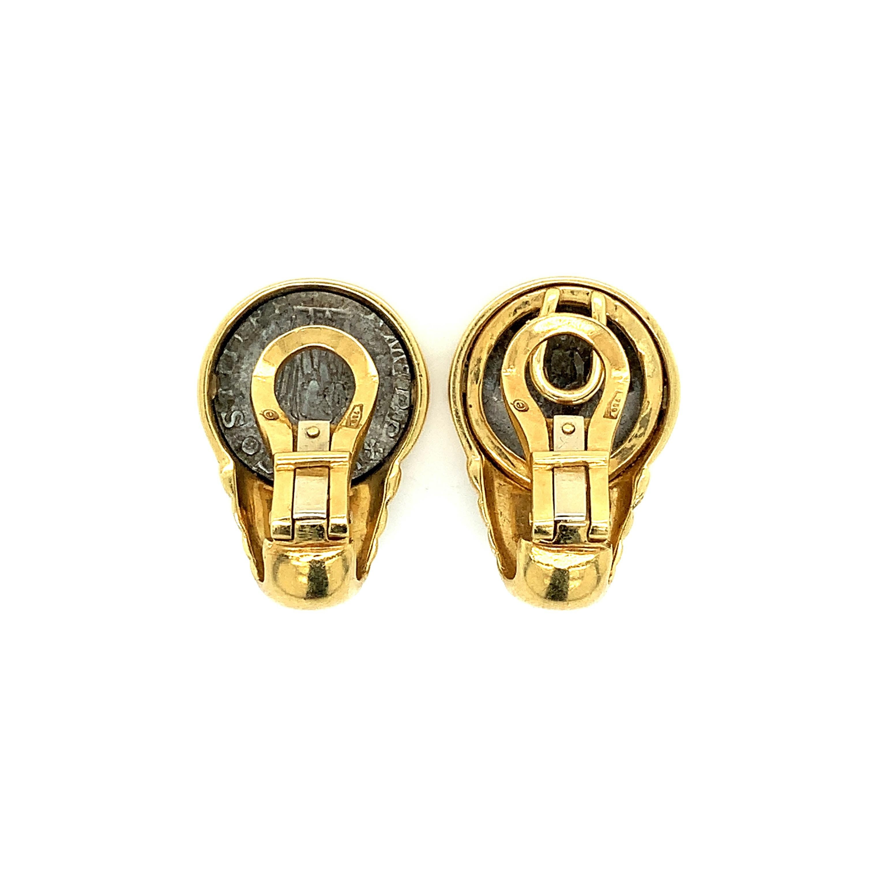 A pair of 18 karat yellow gold ear clips with a replica of Roman coins at their center. Total weight: 24.2 grams. Width: 1.8 cm. Length: 2.6 cm.  
