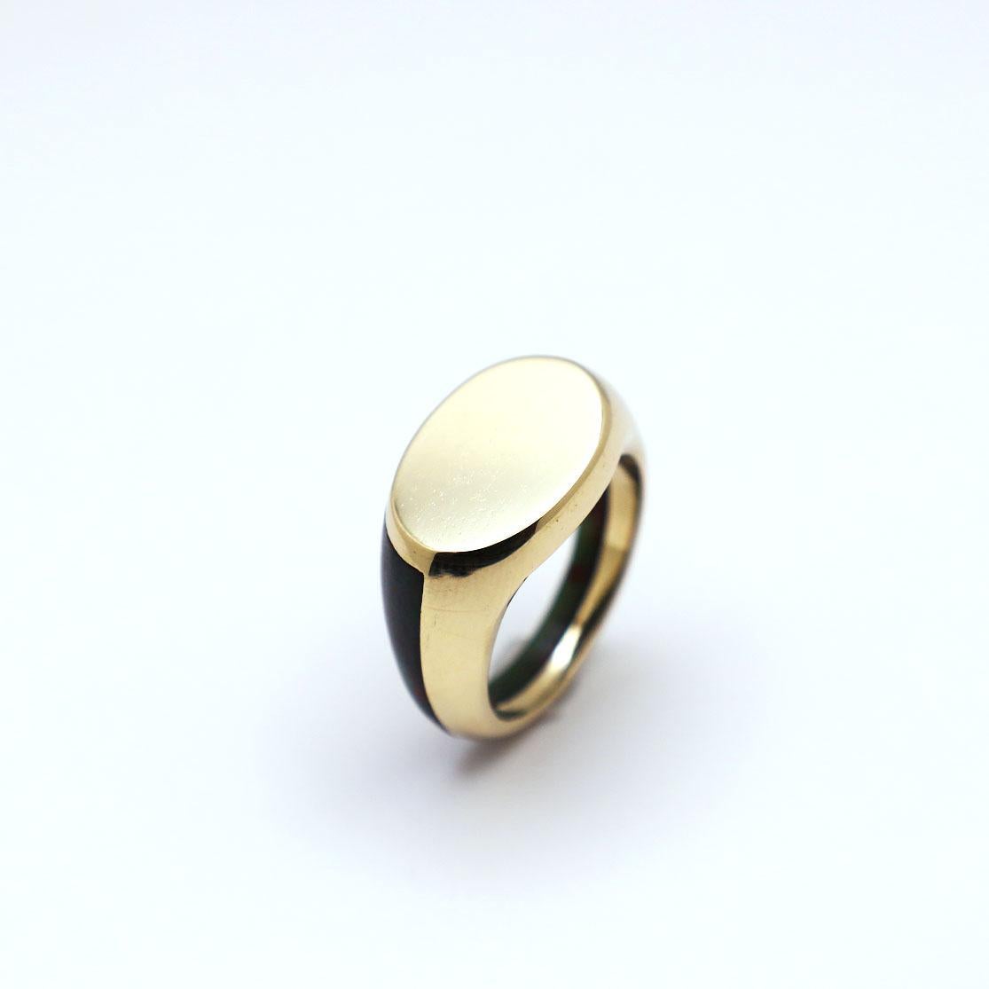 Gold and Bloodstone Signet Ring by KRSN Studio

This contemporary piece combines the traditional signet and hololith rings. The piece features a half gold, half bloodstone body for a striking yet minimal silhouette.

Angelo Jones is a Barbadian born
