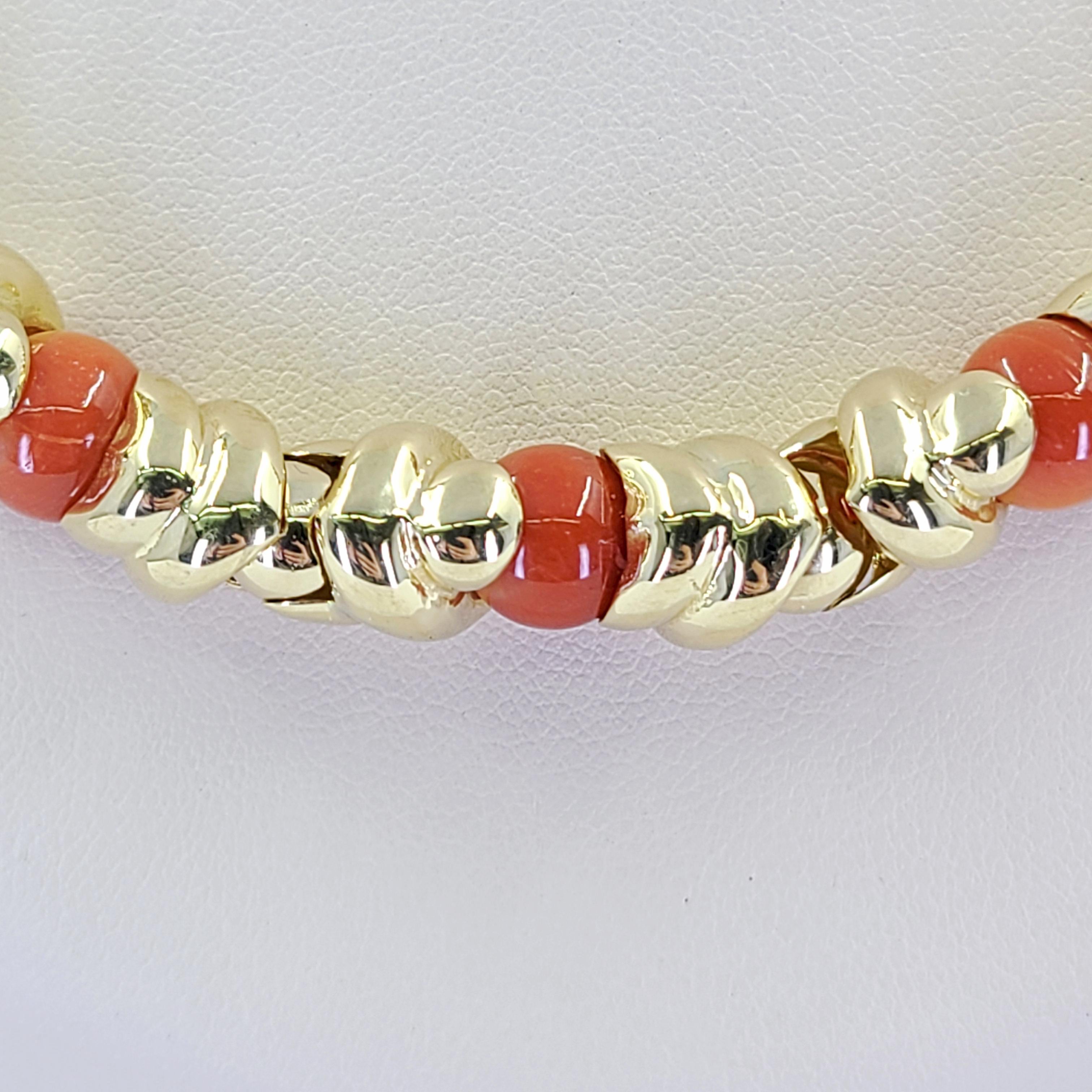 18 Karat Yellow Gold Link Collar Necklace Featuring 21 Round 8mm Coral Beads. 18.5 Inches Long With Hidden Box Clasp and Figure 8 Safety. Finished Weight Is 69.1 Grams. Matching bracelet available separately.