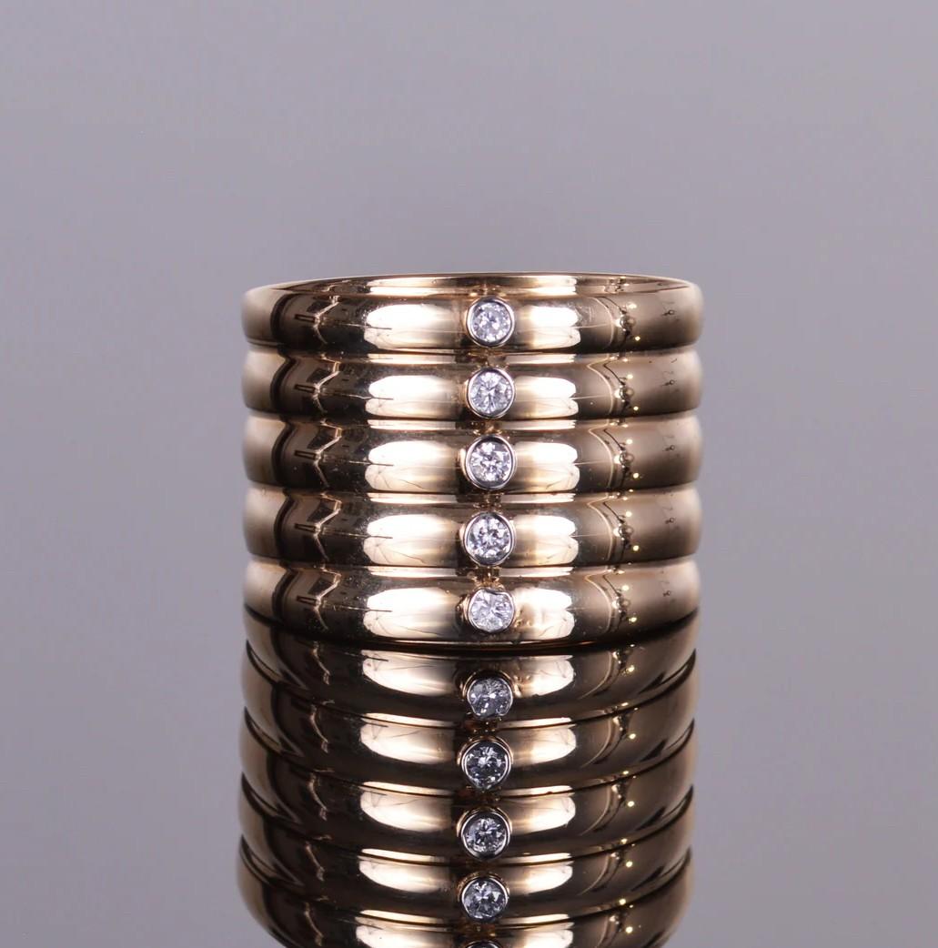 This cuff ring is delicate and beautiful! With a vertical row of .12 carat diamonds, all set in 14k yellow gold.  Size 6.5    Weight 10.6 grams. Ring is preowned.