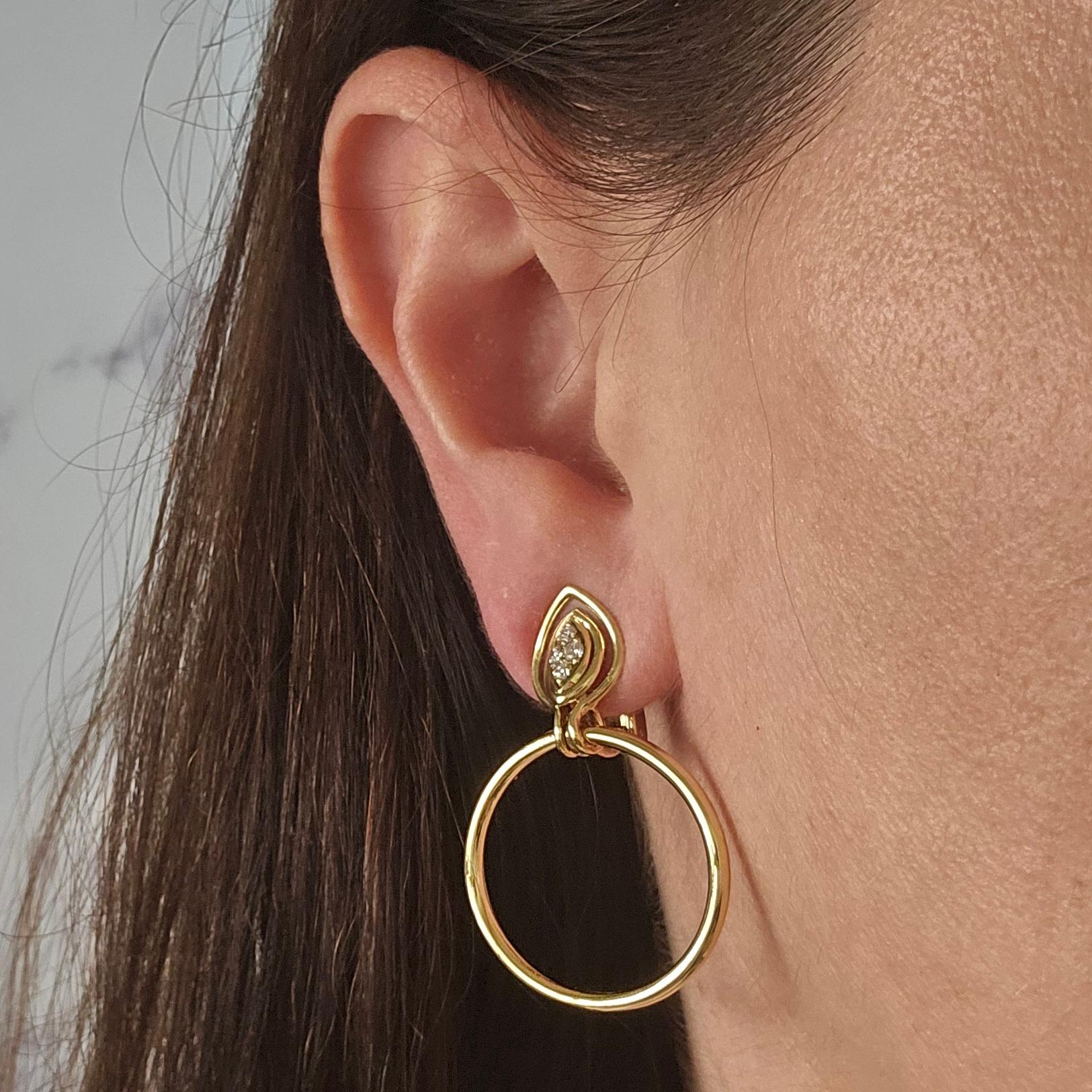 18 Karat Yellow Gold Earrings Featuring a Circular Drop Design Featuring 8 Round Diamonds of VS Clarity and H Color Totaling 0.24 Carats. 1.5 Inches Long with Clip On Back. Post added at no cost, upon request, prior to shipping. Finished Weight is