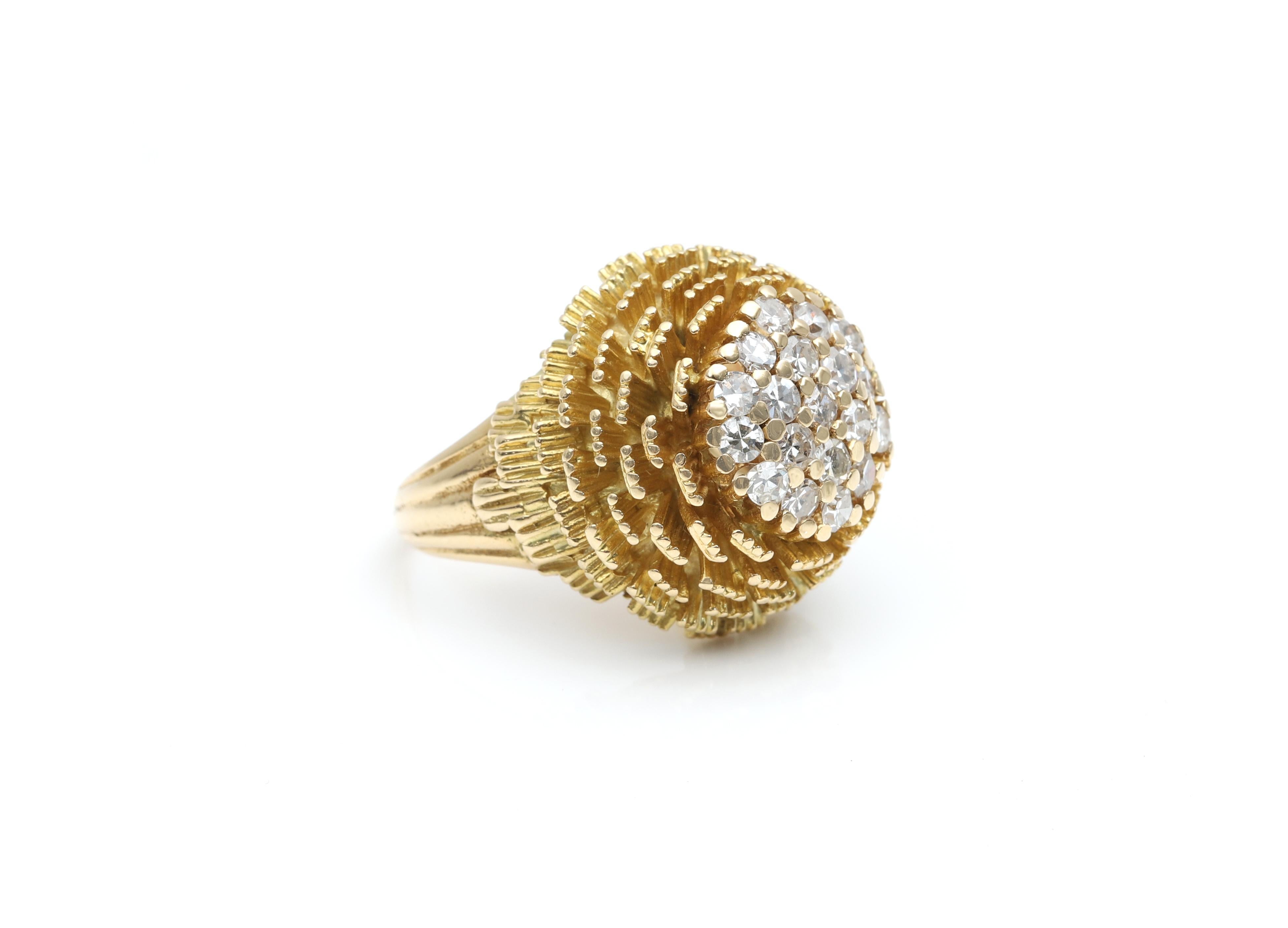 Yellow gold and diamonds cocktail ring, designed in a tridimensional round capsule shape, with layers on the sides, and completed in the top by 19 diamonds in brilliant cut, set in pavé style, with a total weight of approximately 1 ct.

The ring is