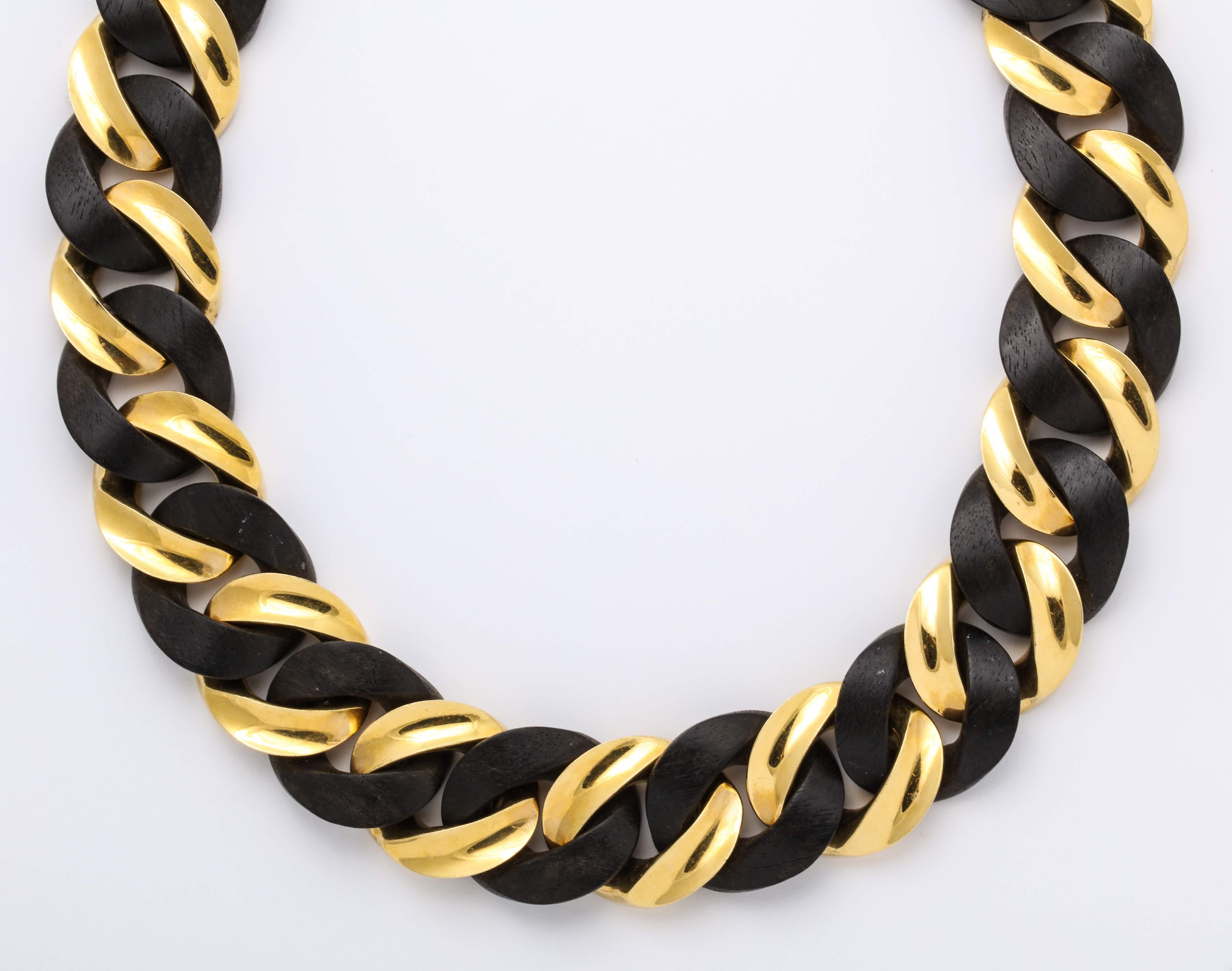 Urban and chic 18 Karat yellow gold concave curb links alternating with convex ebony wood link necklace.

Dimensions: Length: 17 1/2 inches  Width: 15/16 inches  Elevation: 1/4 inches

Matching bracelet sold separately.