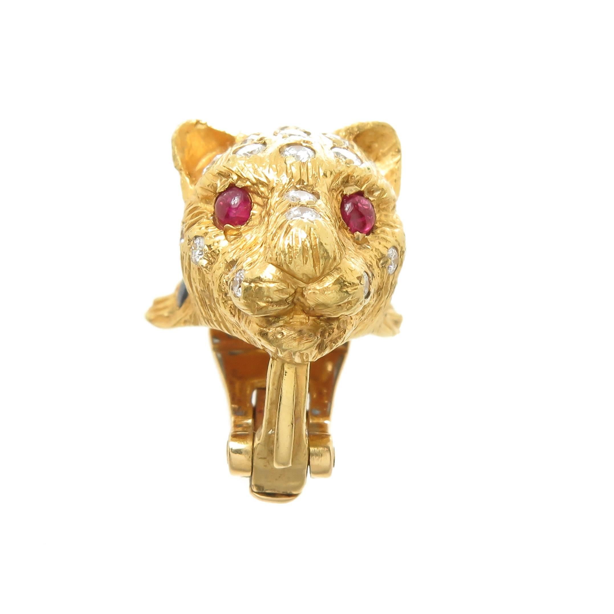 Circa 1990 18K Yellow Gold Cougar Earrings, Finely detailed and textured and measuring 1 inch in length and 5/8 inch wide. Set with Round Brilliant cut Diamonds totaling 1 carat and grading as G-H in color and VS in Clarity, Cabochon Rubies for the