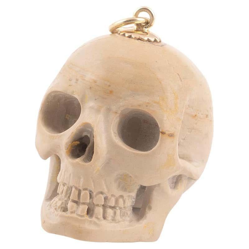 Retro Yellow Gold and Lava Skull Pendant For Sale