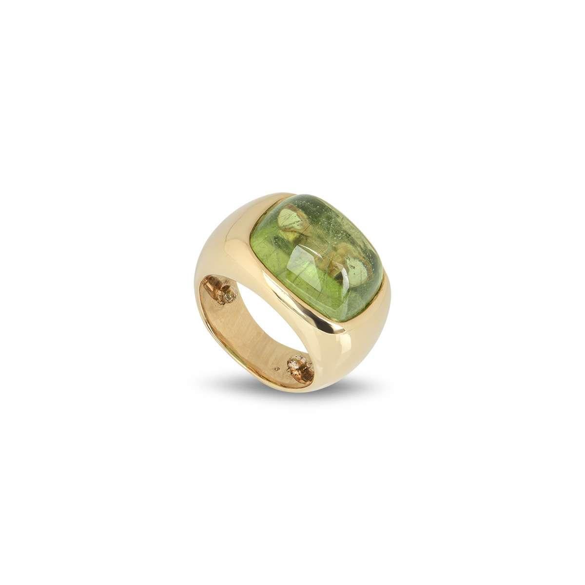 An 18k yellow gold dress ring by Rossi. The ring is set to the centre with a cushion shaped cabochon peridot, measuring approximately 12mm x 16mm. The ring is a size UK L - EU 51 - US 5.5 but can be adjusted for a perfect fit and has a gross weight