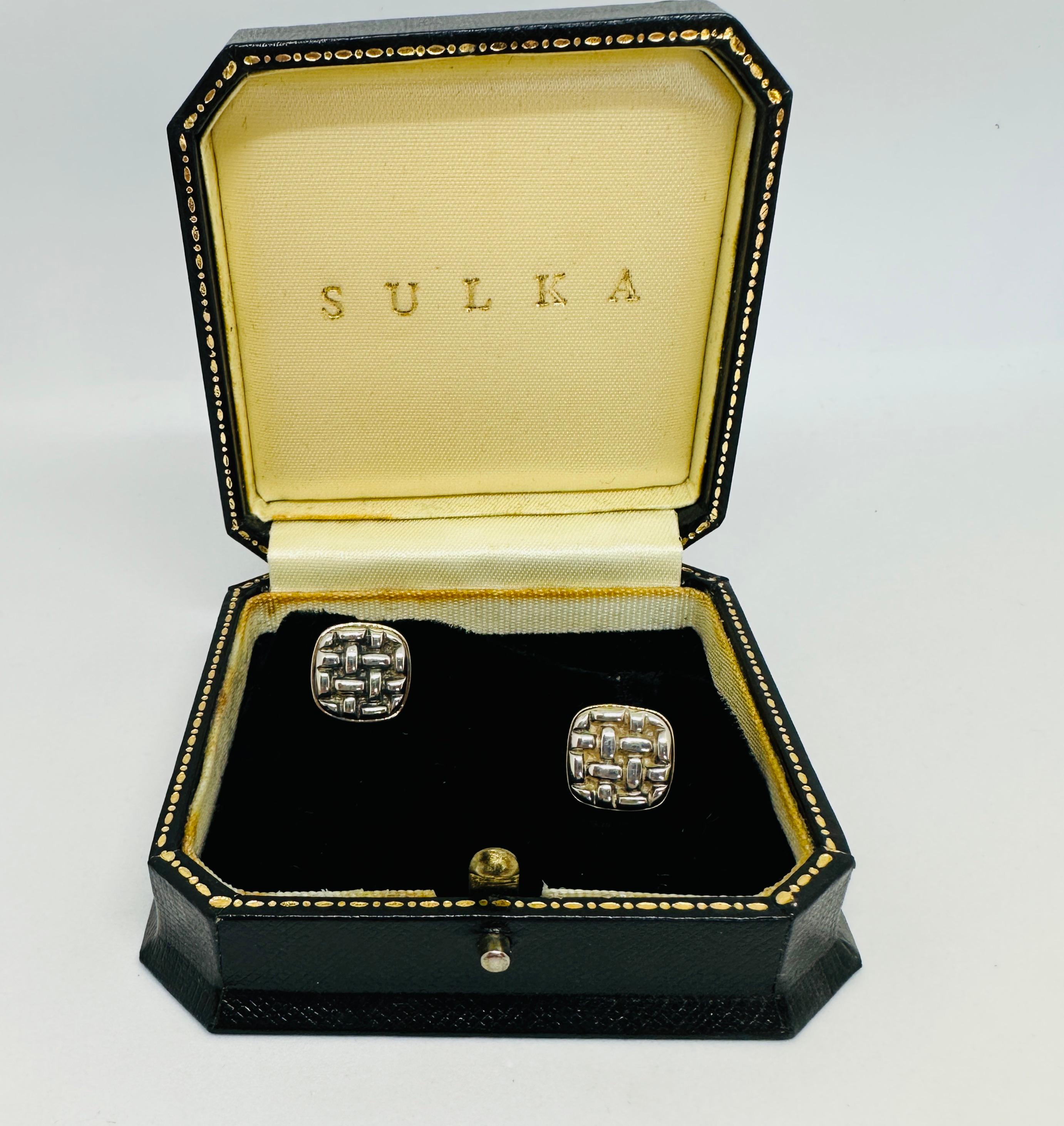 Rare and highly collectible basketweave design cufflinks in 18K yellow gold with sterling silver made by Trianon and retailed by Amos Sulka & Company. These cufflinks have never been worn and come in their original fitted Sulka case.

The cufflinks