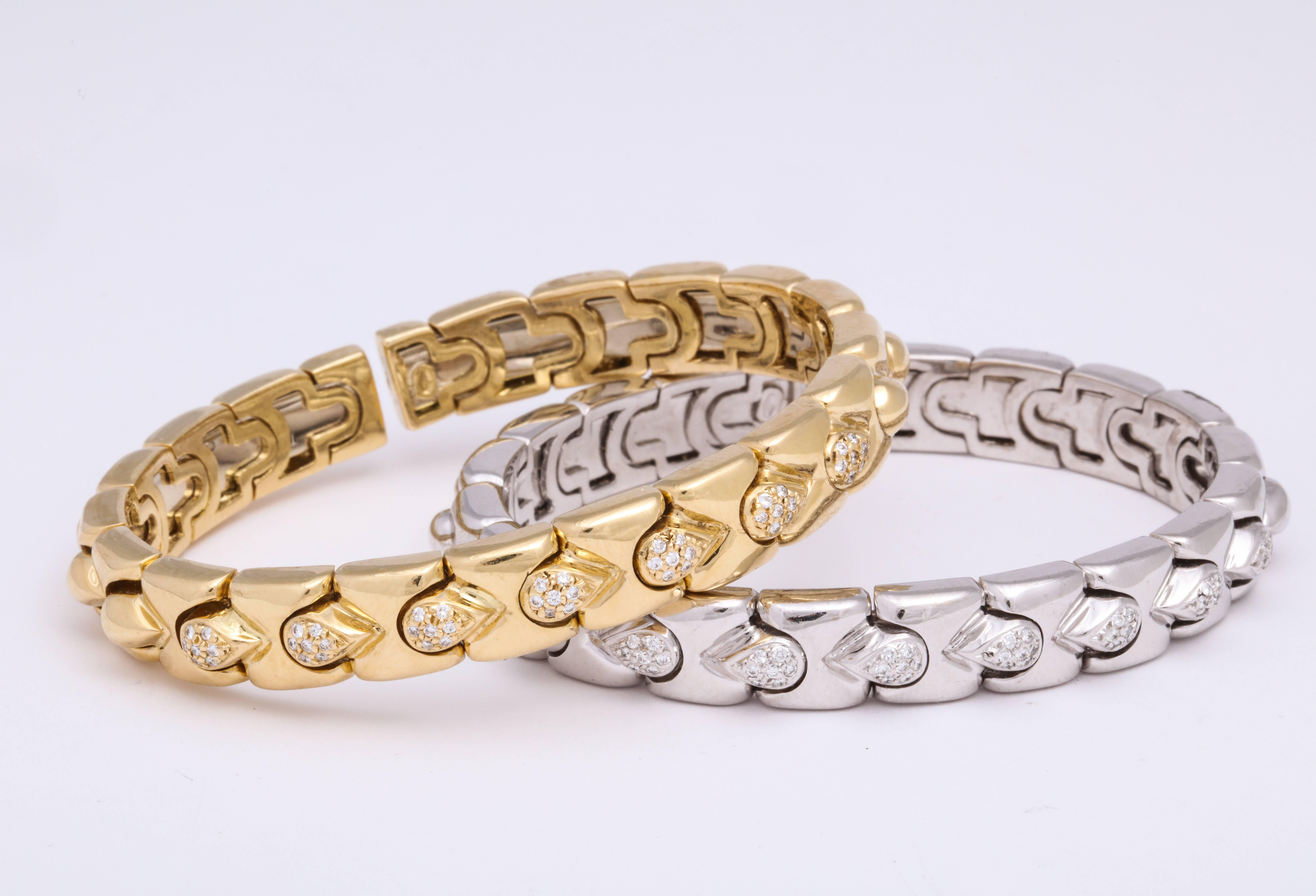 Contemporary 18 Karat yellow gold and matching 18 Karat white gold stack bracelets composed of polished links alternating with pave'-set diamond accented links: combined total weight: 0.50 carats mounted on spring for a fitted wear. This is offered
